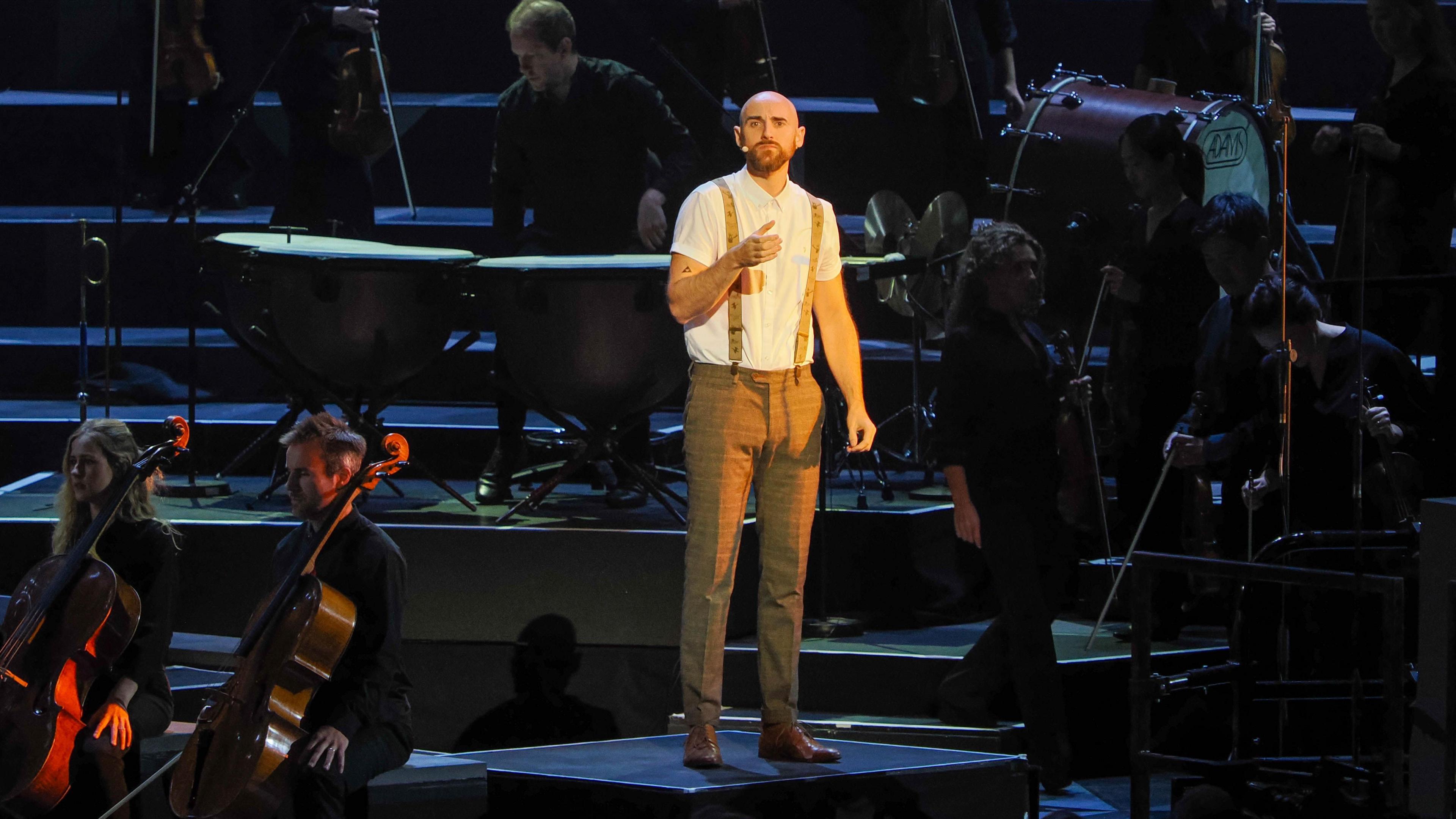 Thomas Simper on stage at the Royal Albert Hall, surrounded by the Aurora Orchestra.