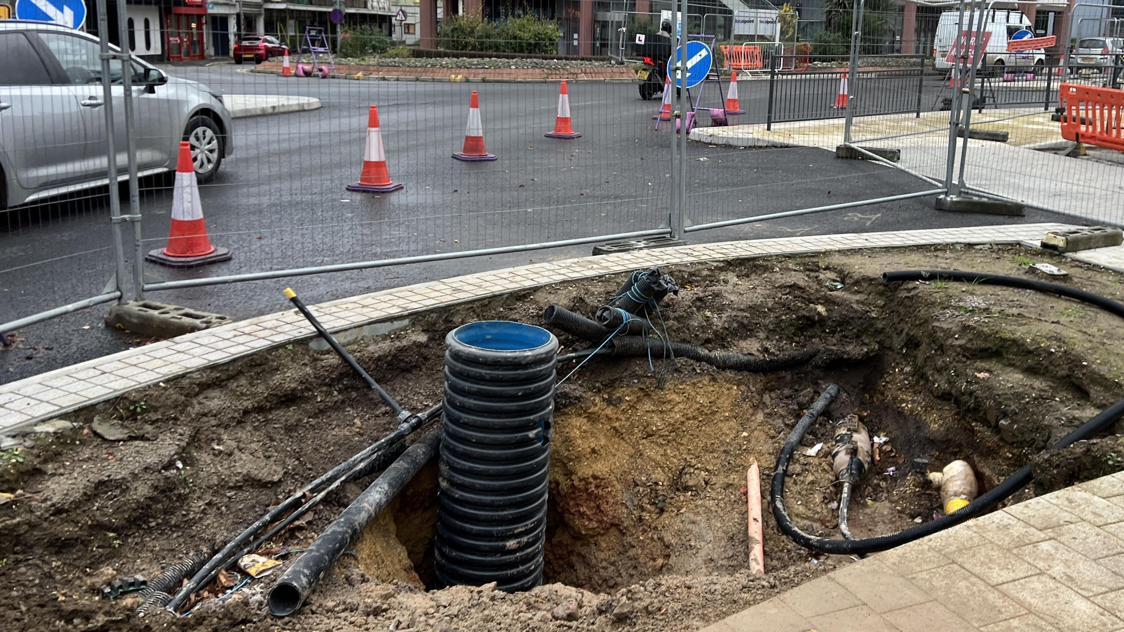 Piping sticking up out of the ground on the edge of the traffic diversion