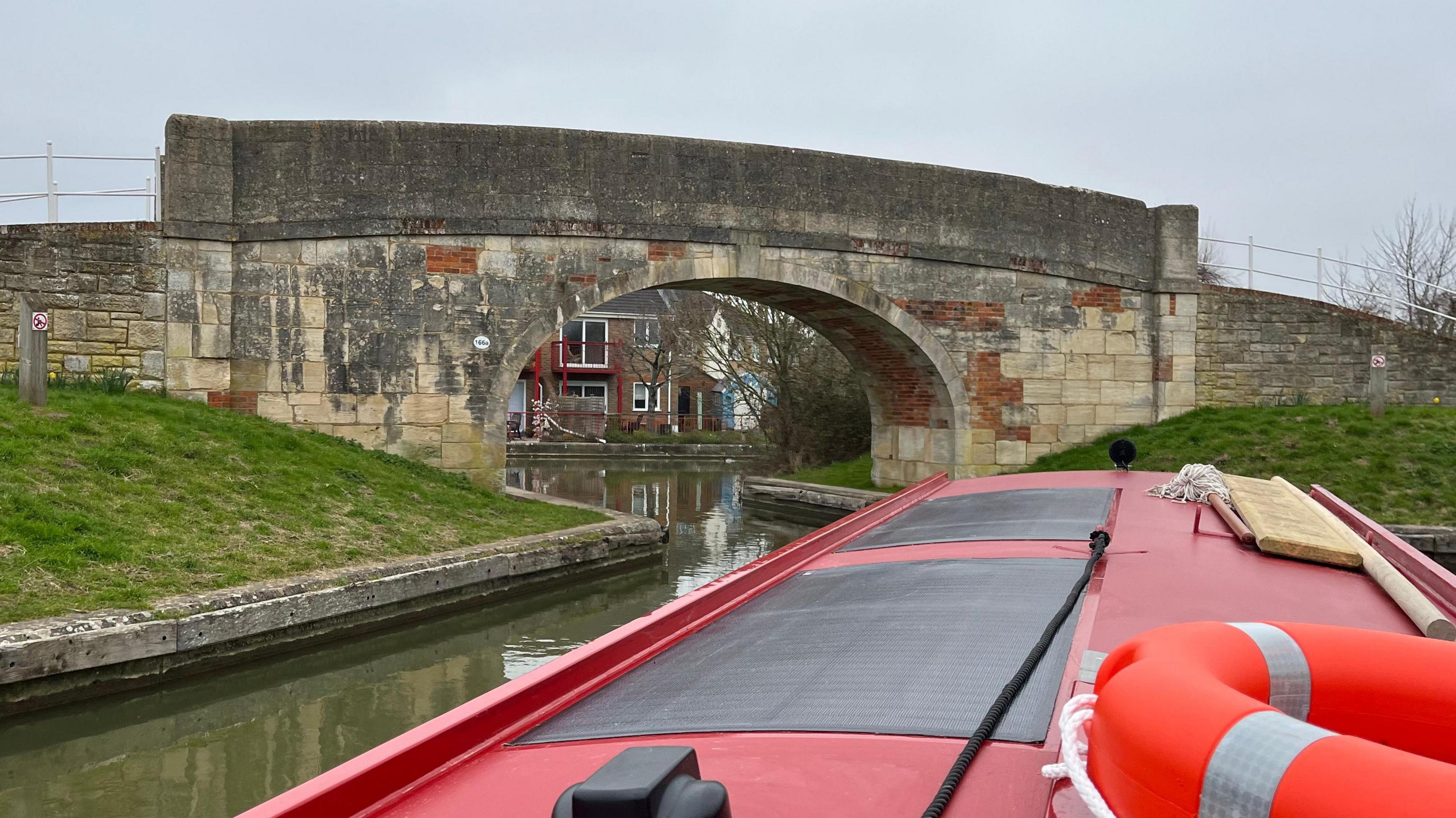 Canal boat navigating Hilperton Bridge on K& A canal