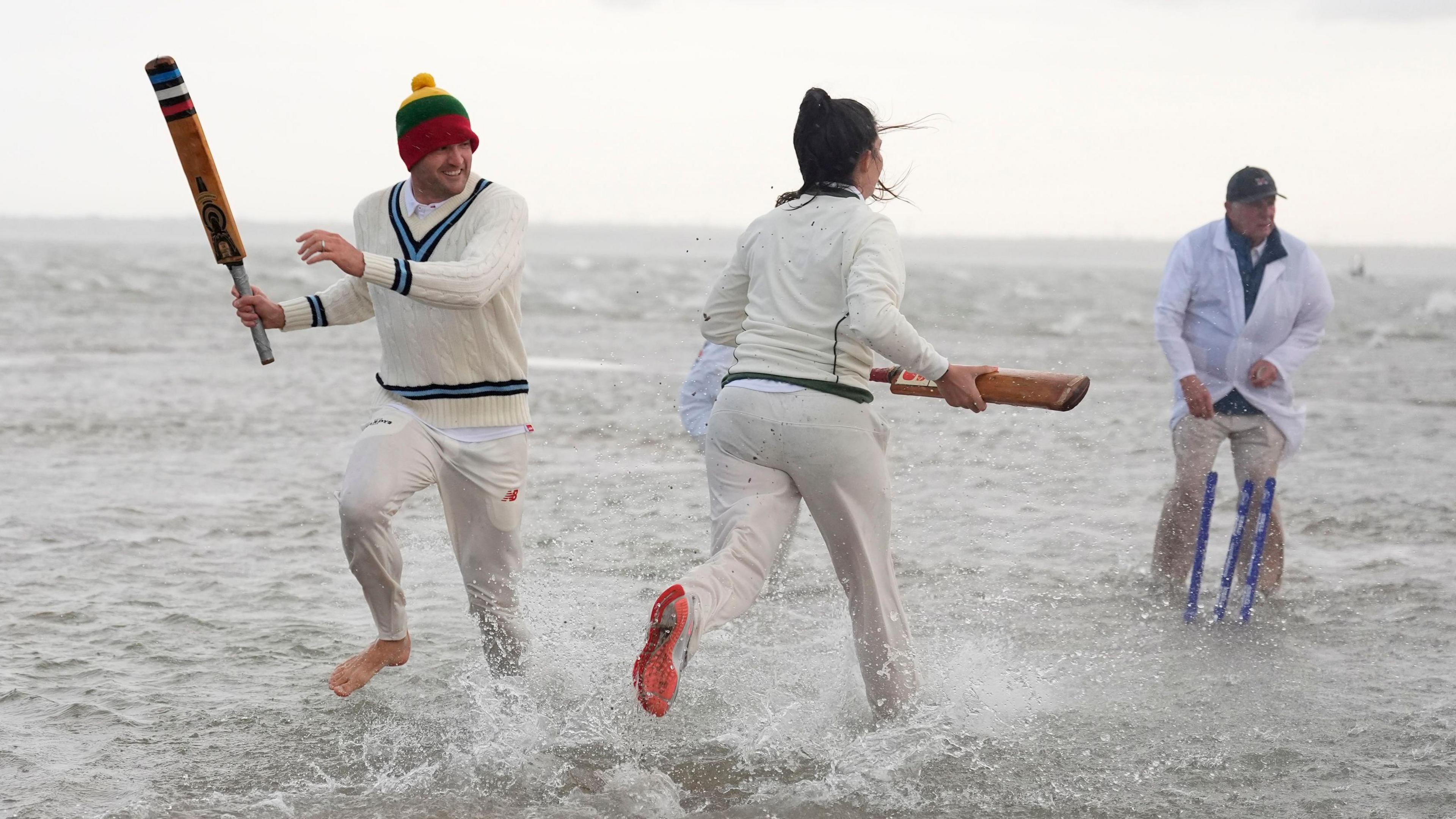 Members of the Royal Southern Yacht Club and the Island Sailing Club take part in the annual Brambles cricket match on the Bramble Bank sandbank in the middle of the Solent at low tide.