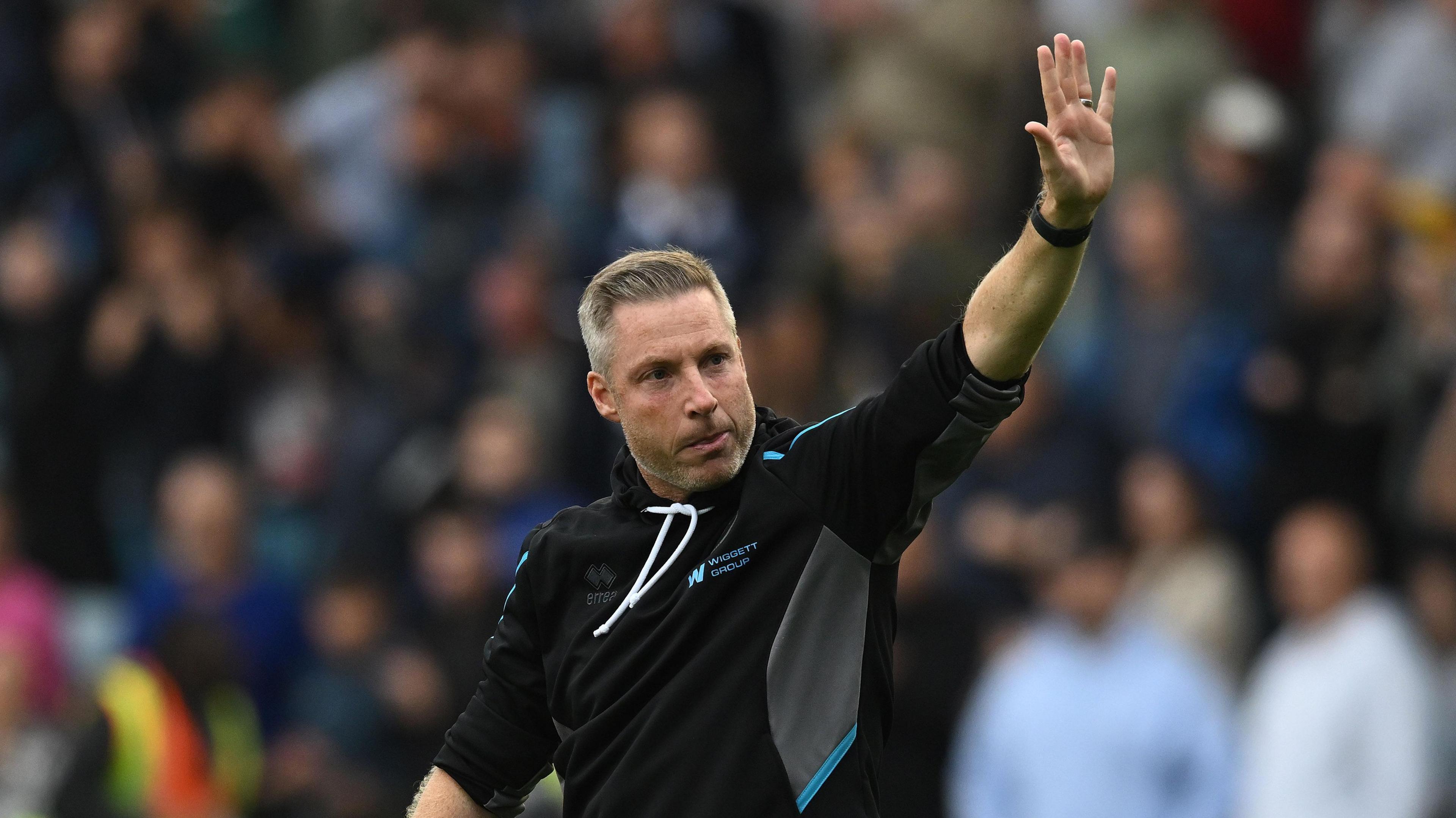 Neil Harris waves to fans