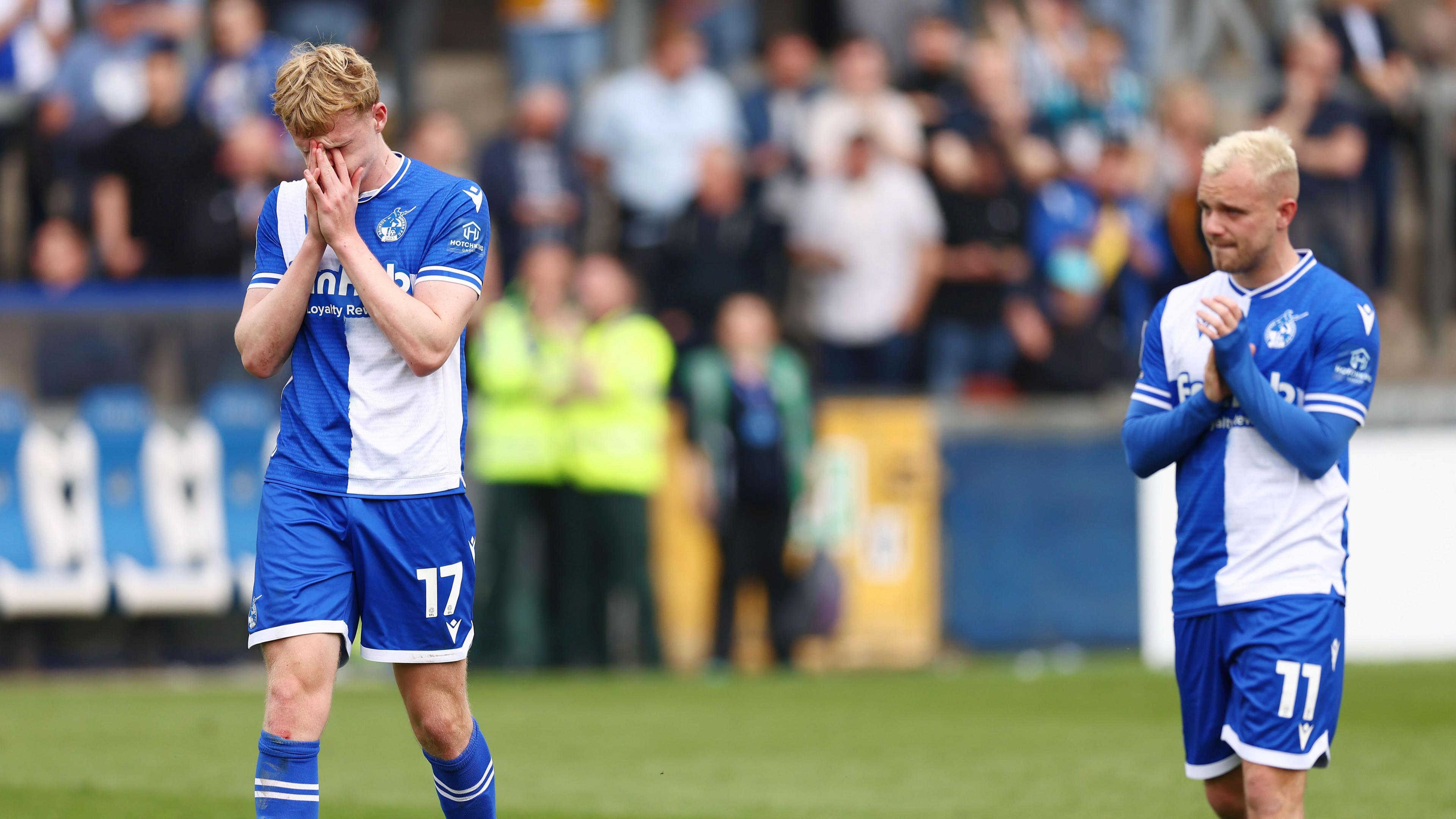 Connor Taylor holds his head in his hands and Luke Thomas applauds fans at the full-time whistle following defeat to Reading