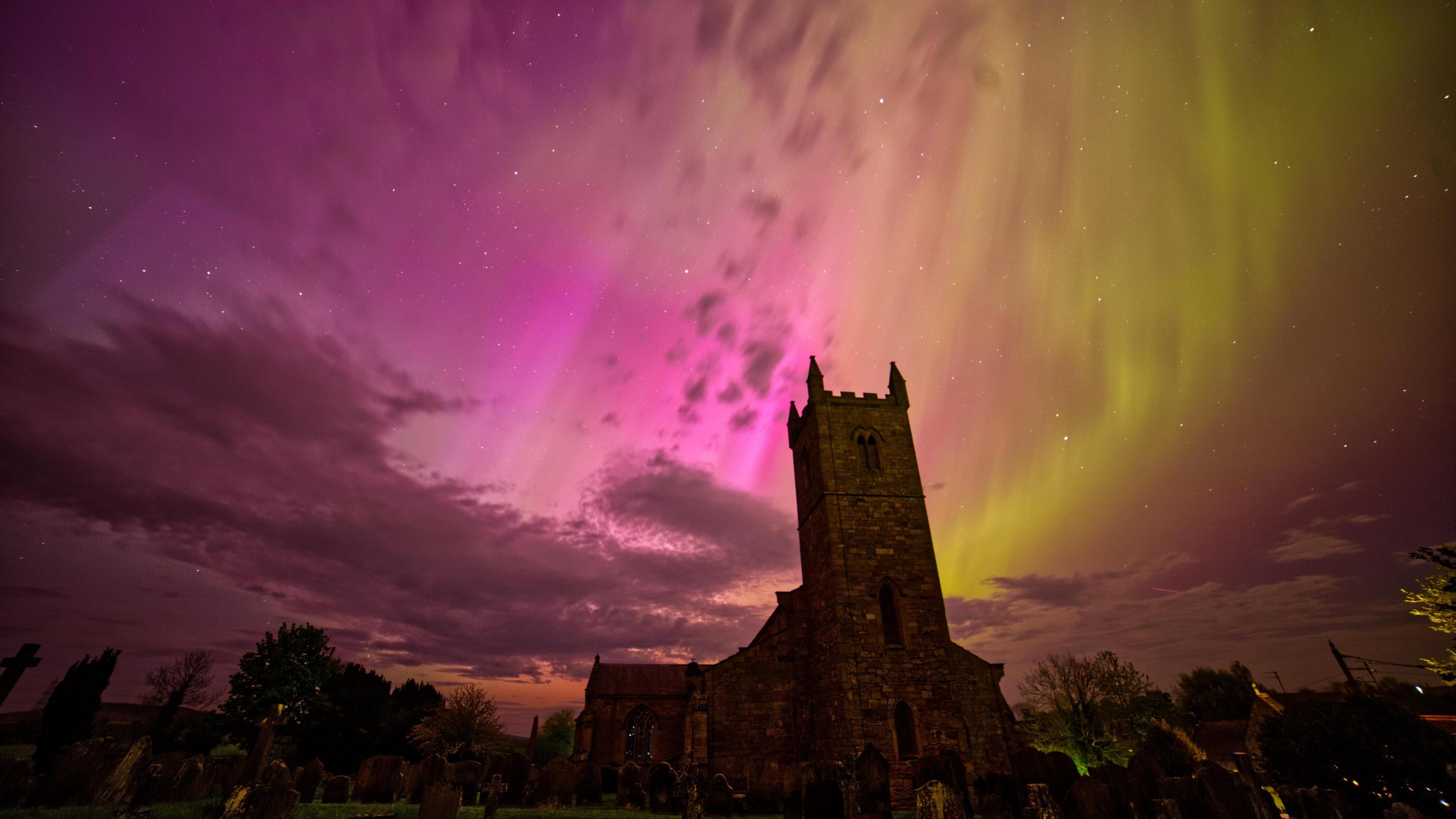 A church with a colourful sky beyond