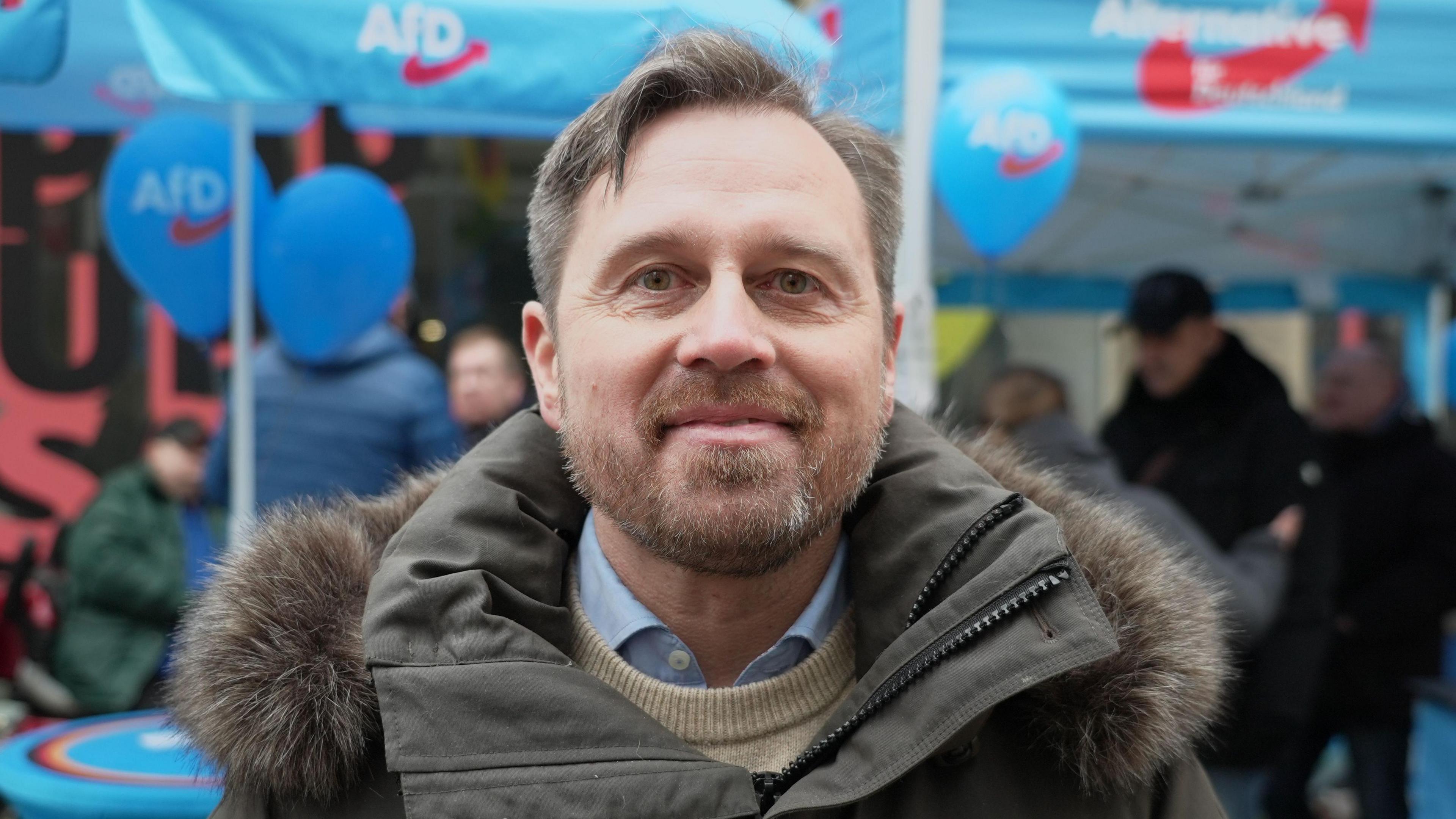 Jörg Lange pictured at an event with AfD balloons.