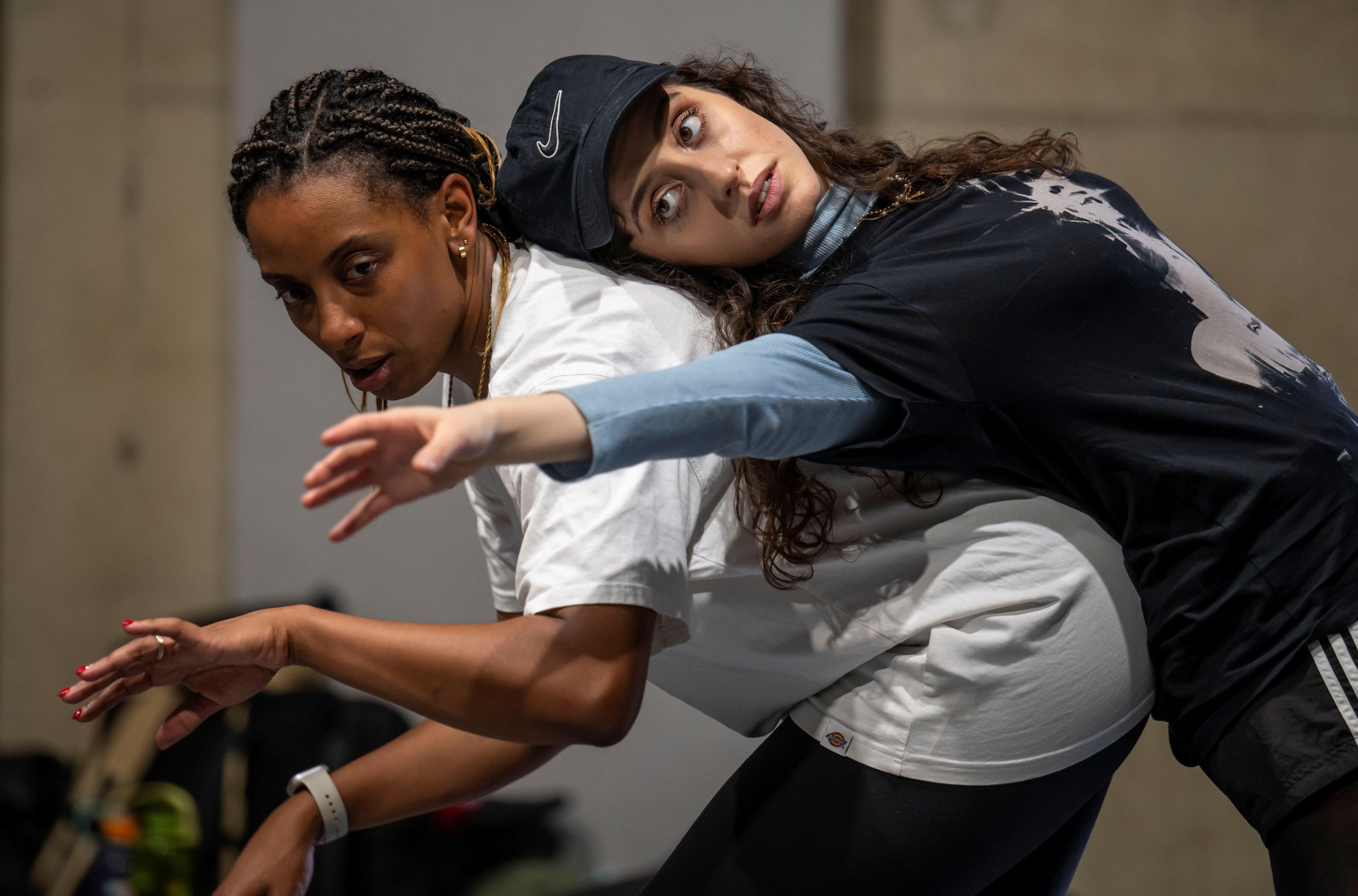 Two actresses, one leaning on the back of the other, rehearse for Romeo and Juliet at Bristol Old Vic