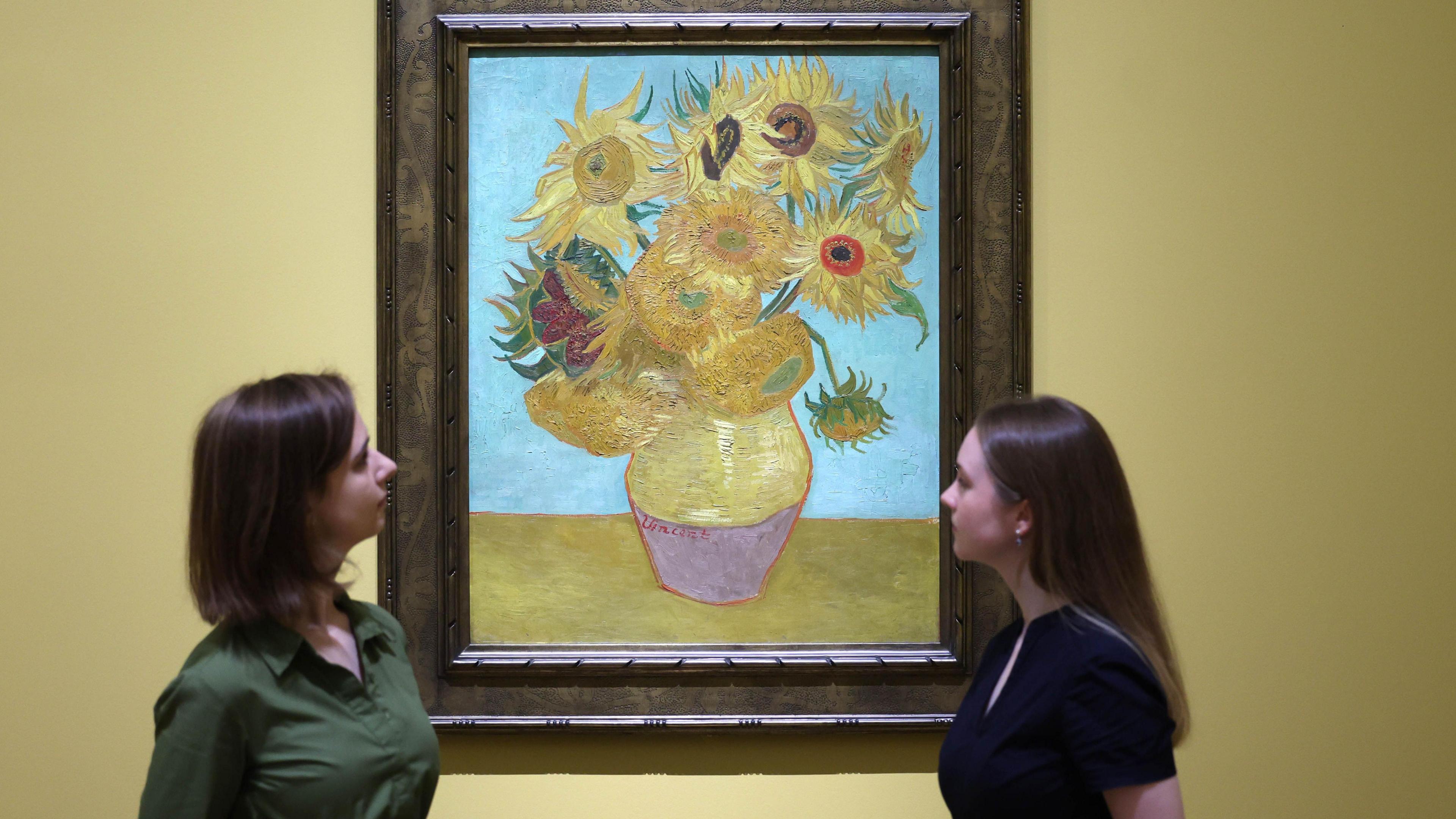 Gallery workers view Dutch artist Vincent van Gogh's work titled 'Sunflowers' (1889) during a preview for the exhibition 'Van Gogh: Poets and Lovers' at the National Gallery in London, Britain, 09 September 2024