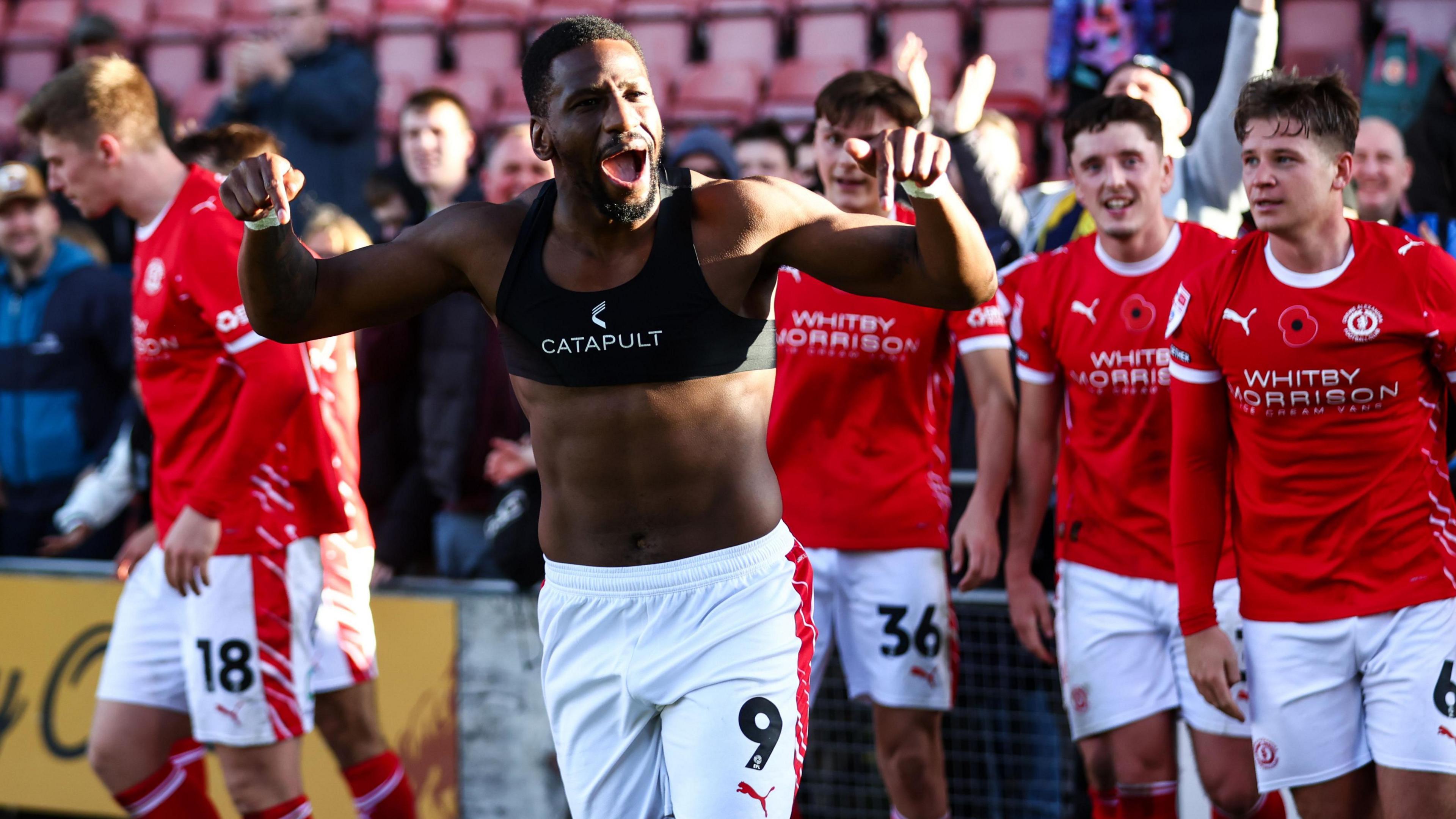 Omar Bogle celebrates with his Crewe team-mates after scoring on his first match back against Shrewsbury