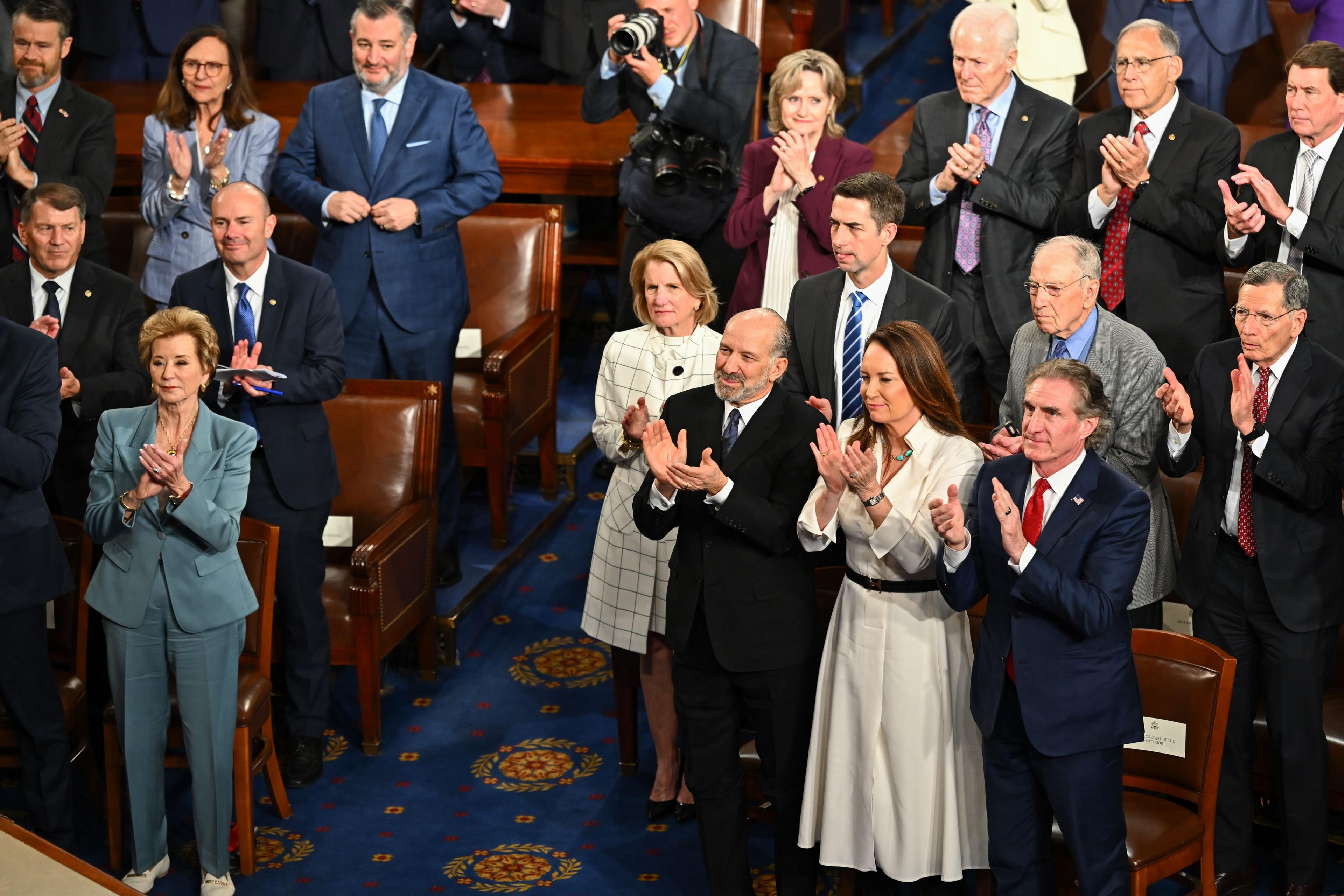 US Politicians stand and clap in the US House Chamber