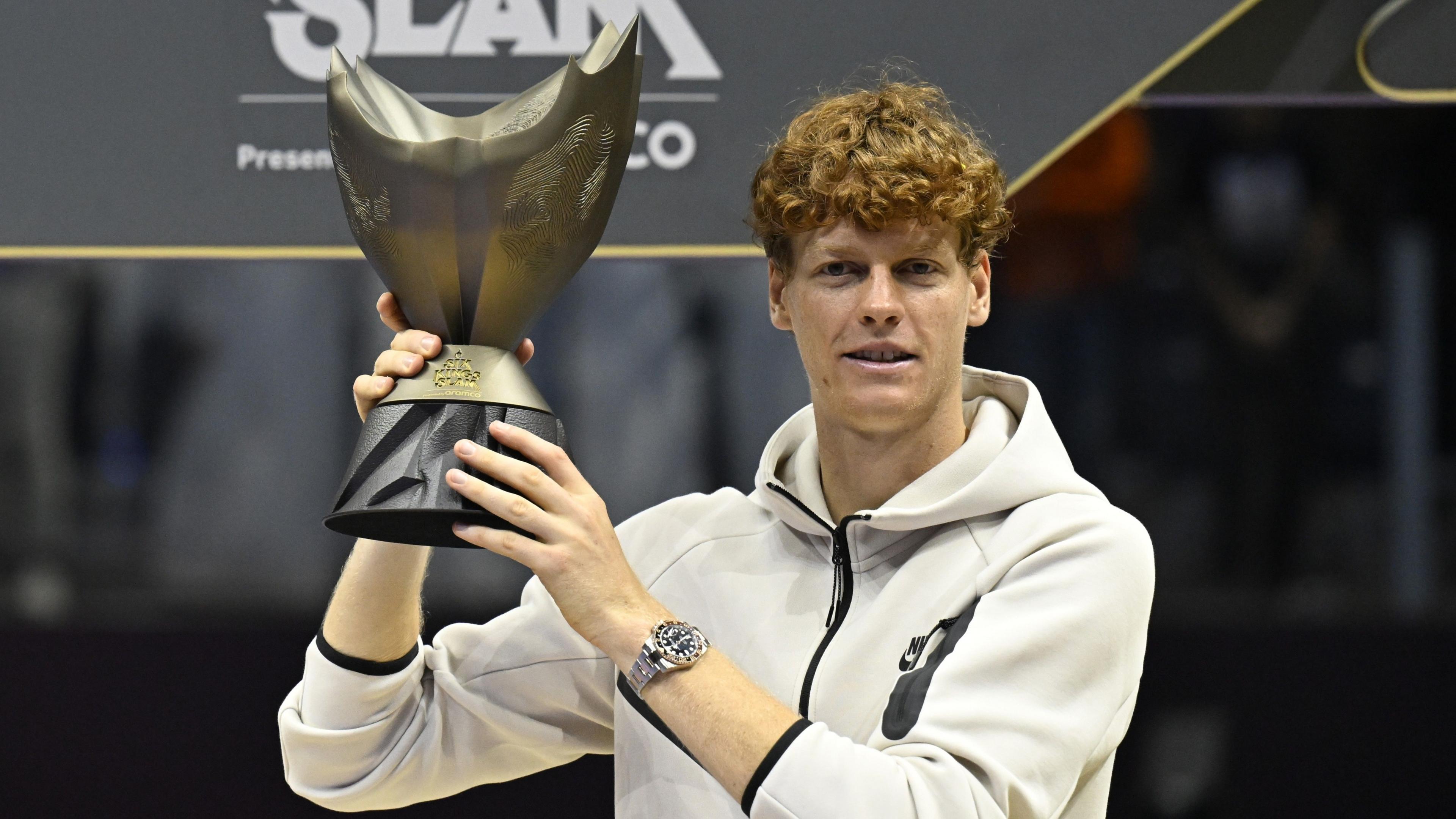 Jannik Sinner holds the Six Kings Slam trophy after his victory over Carlos Alcaraz in the 2024 final
