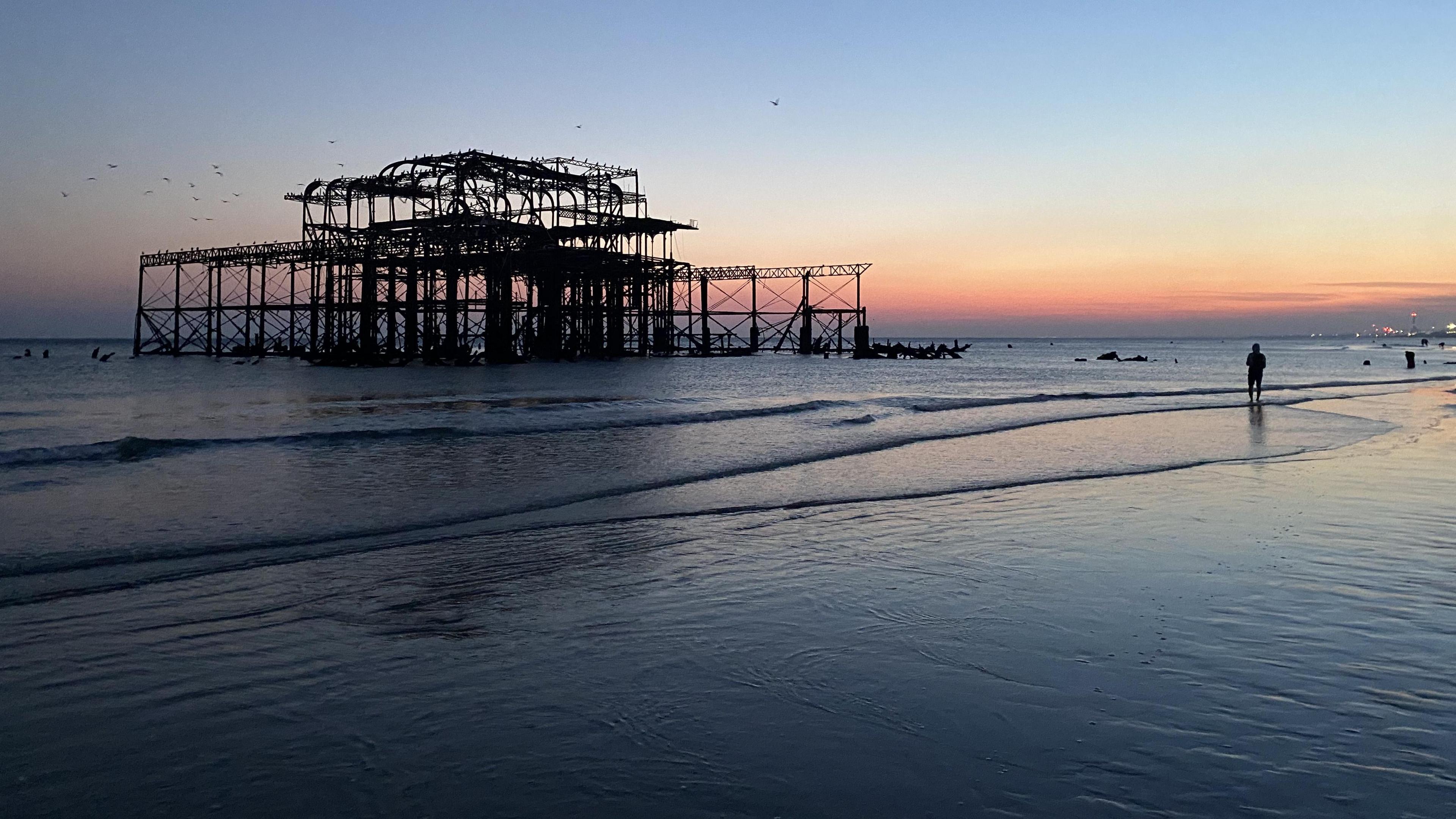 Brighton's West Pier from close-up during a low tide and sunset