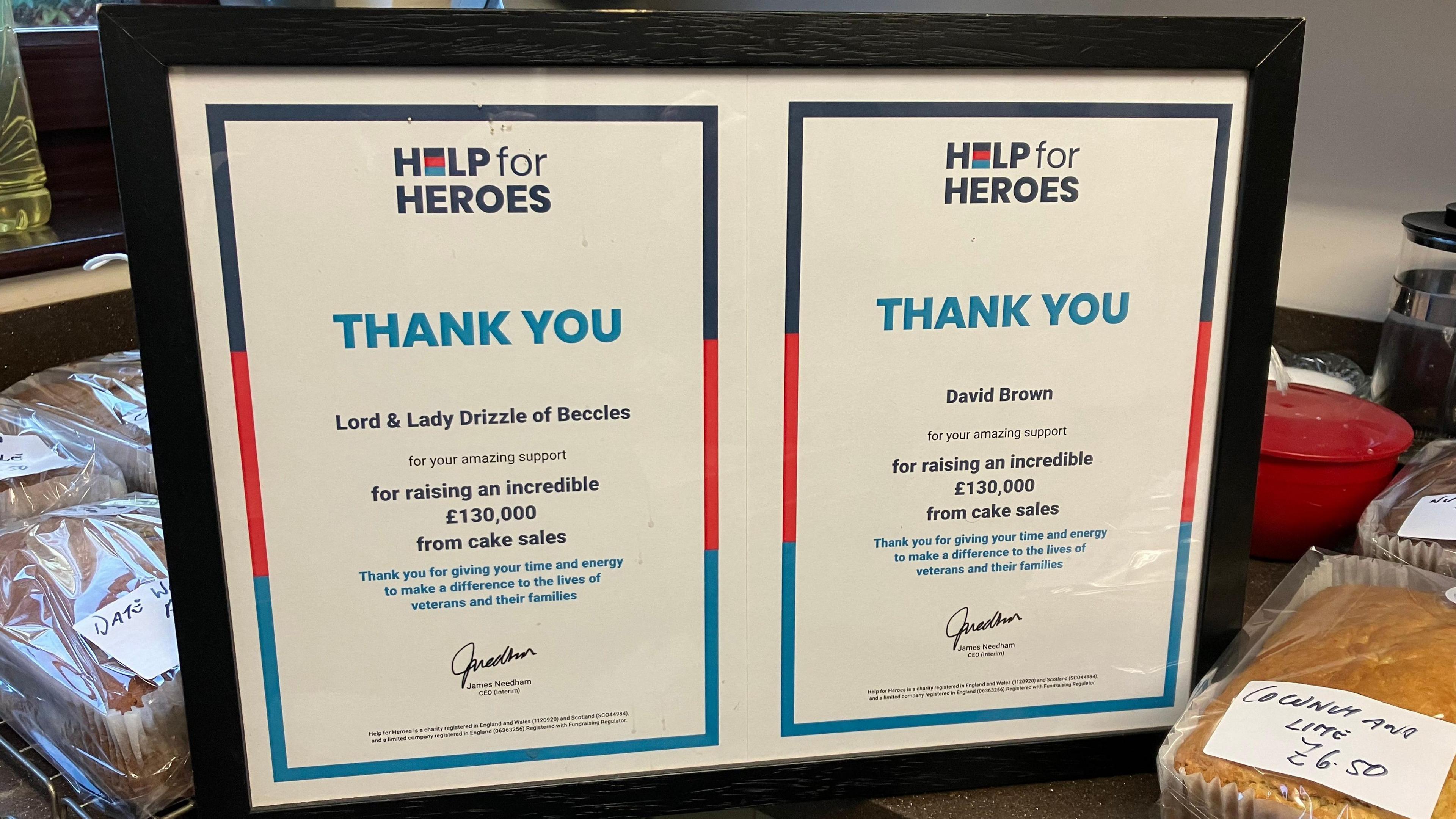 Two framed certificates can be seen from the Help for Heroes charity, one addressed to "Lord and Lady Drizzle of Beccles" and one to David Brown, thanking them for raising £130,000 from cake sales  