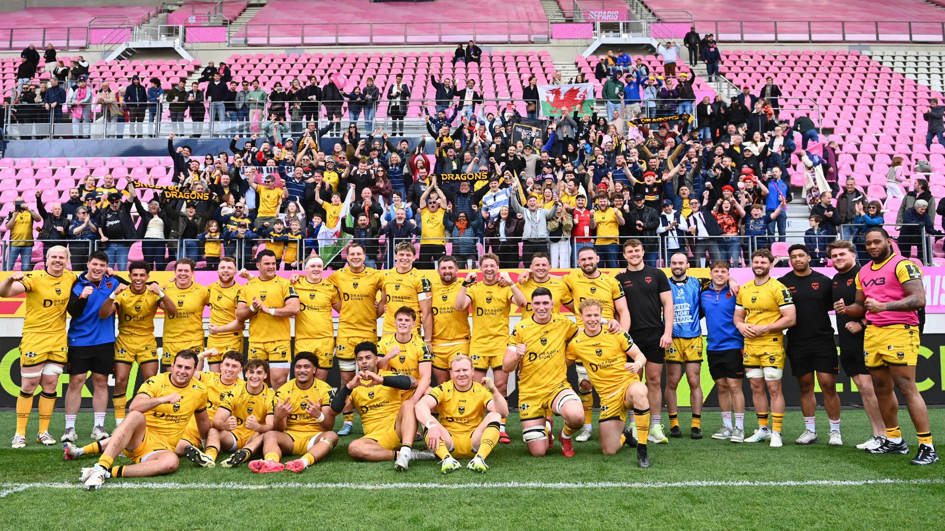 Dragons celebrate with the travelling support after winning at Stade Francais
