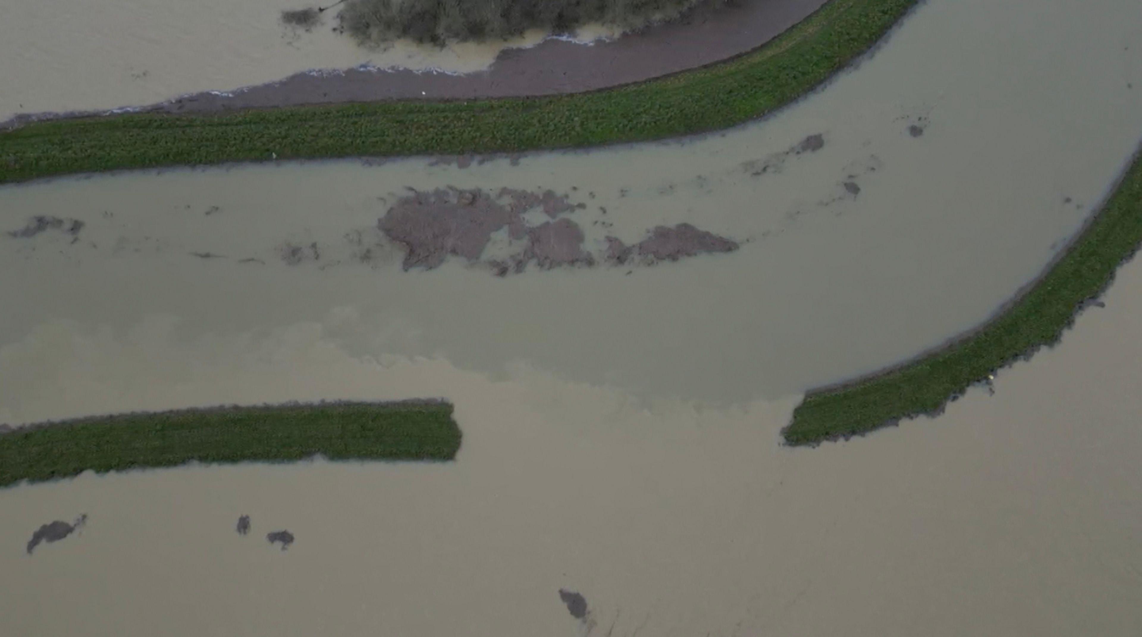 An aerial view of the banks of the Barling's Eau river, the fields surrounding the river are completely flooded. 