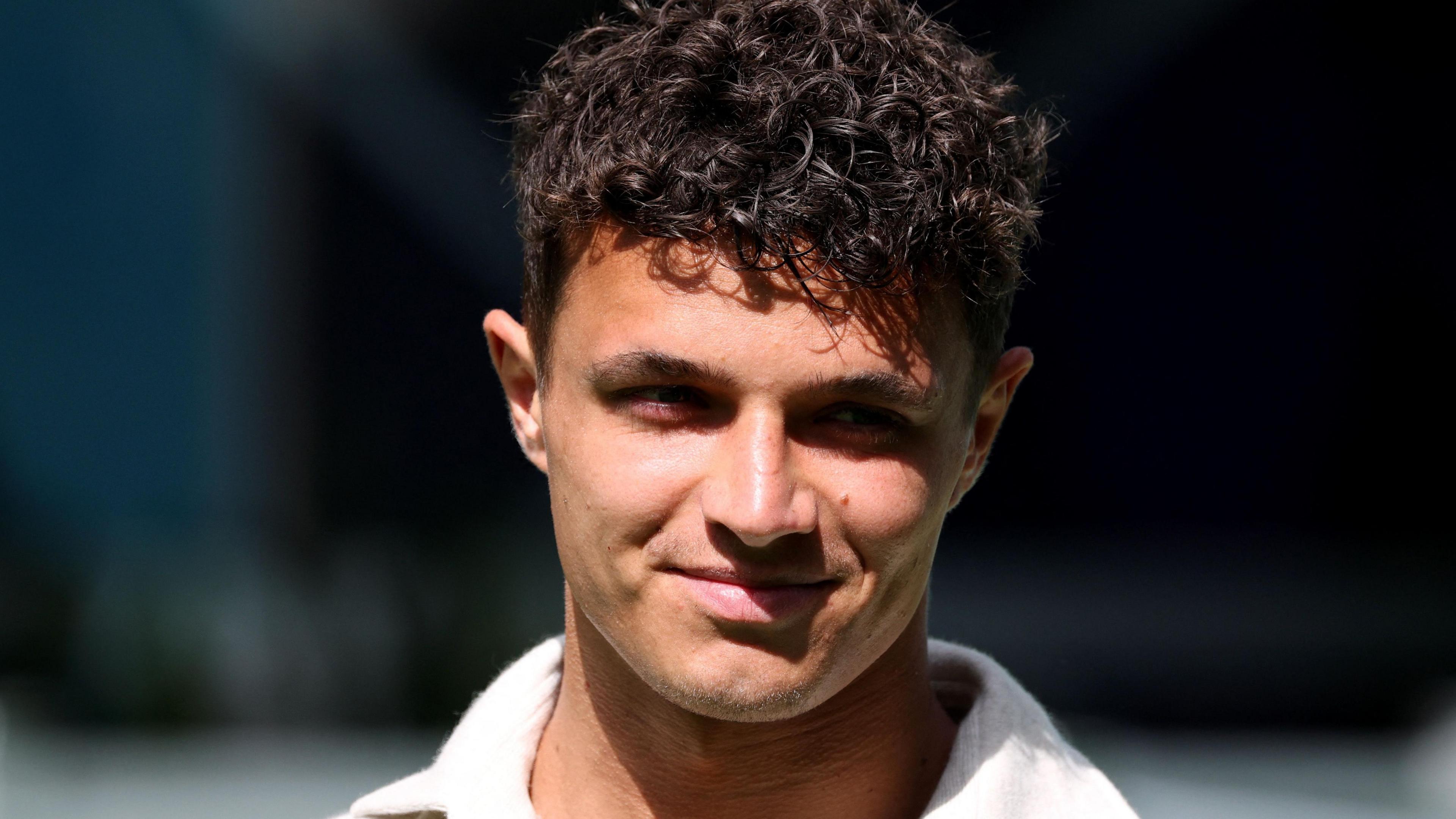 A close-up image of a smiling Lando Norris