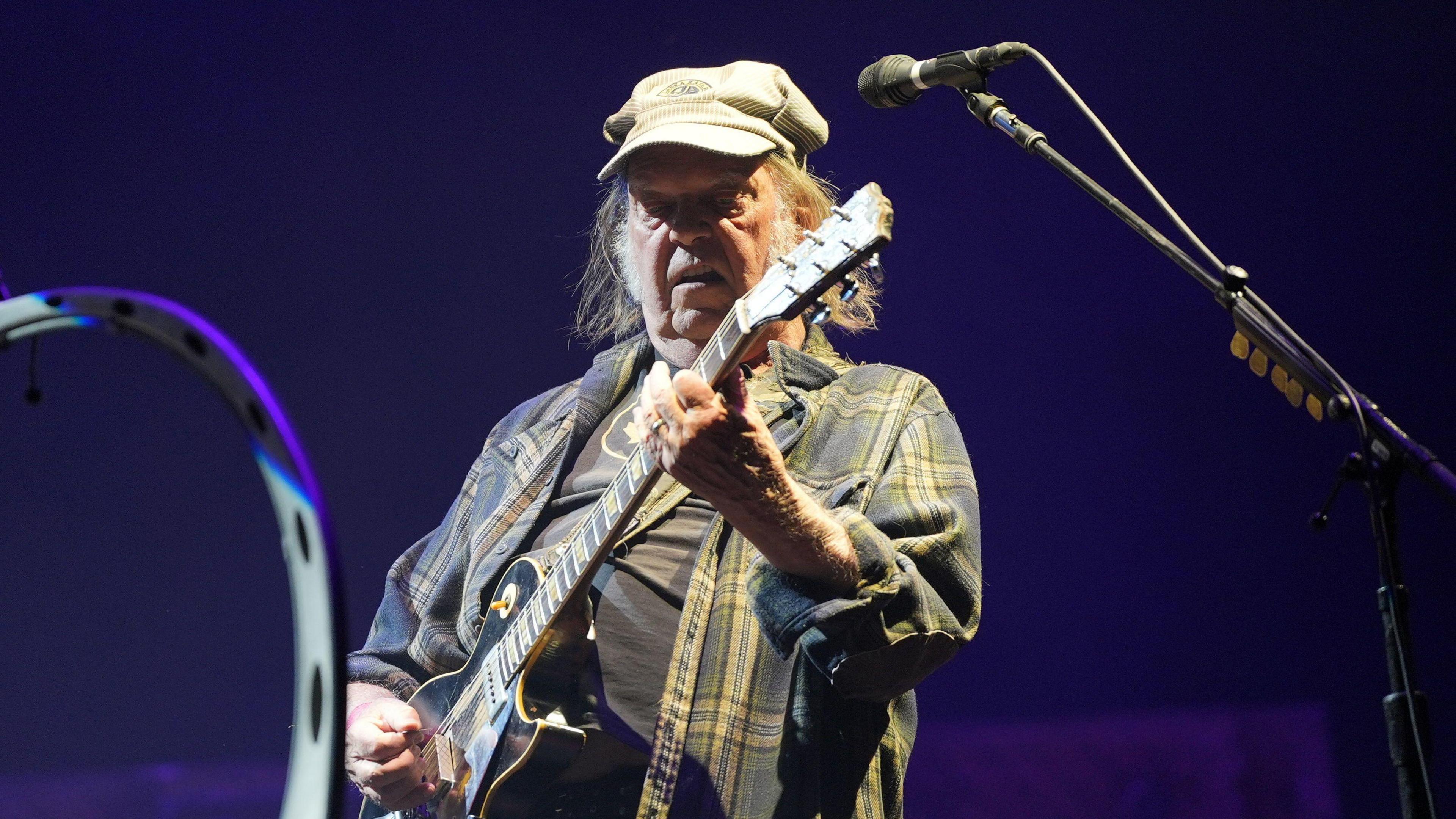 Neil Young performing on the Pyramid Stage during the Glastonbury Festival at Worthy Farm in Somerset.