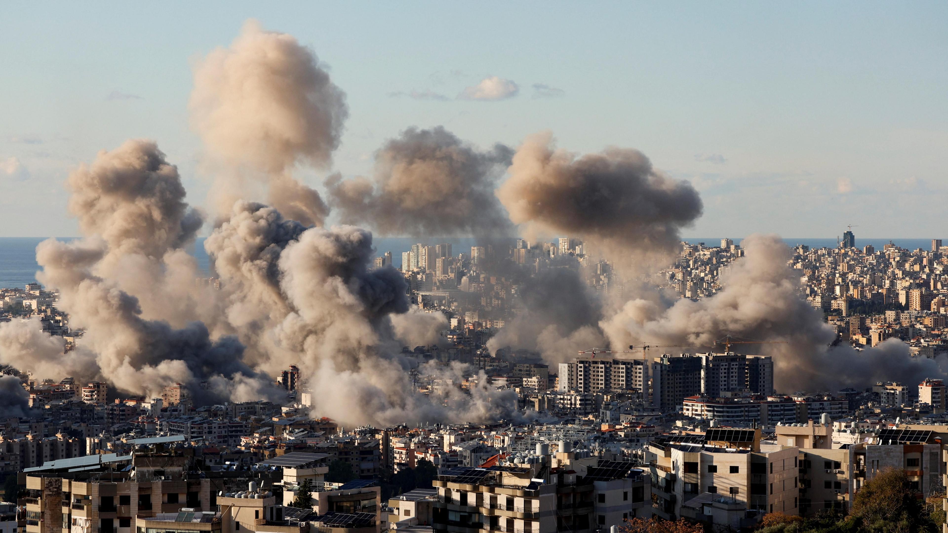 Plumes of smoke rise from Beirut's southern suburbs following a wave of Israeli air strikes (26 November 2024)