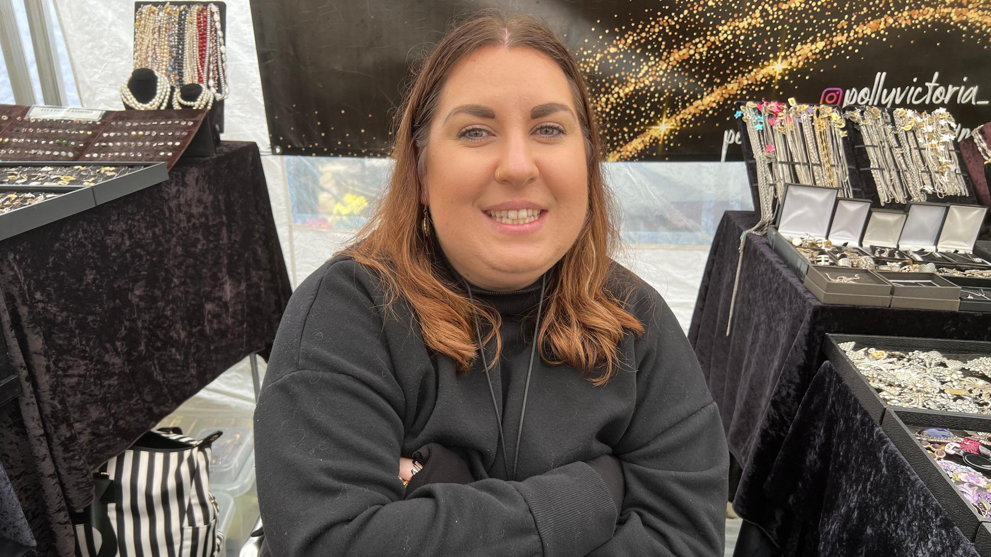 A market trader sits at her stall