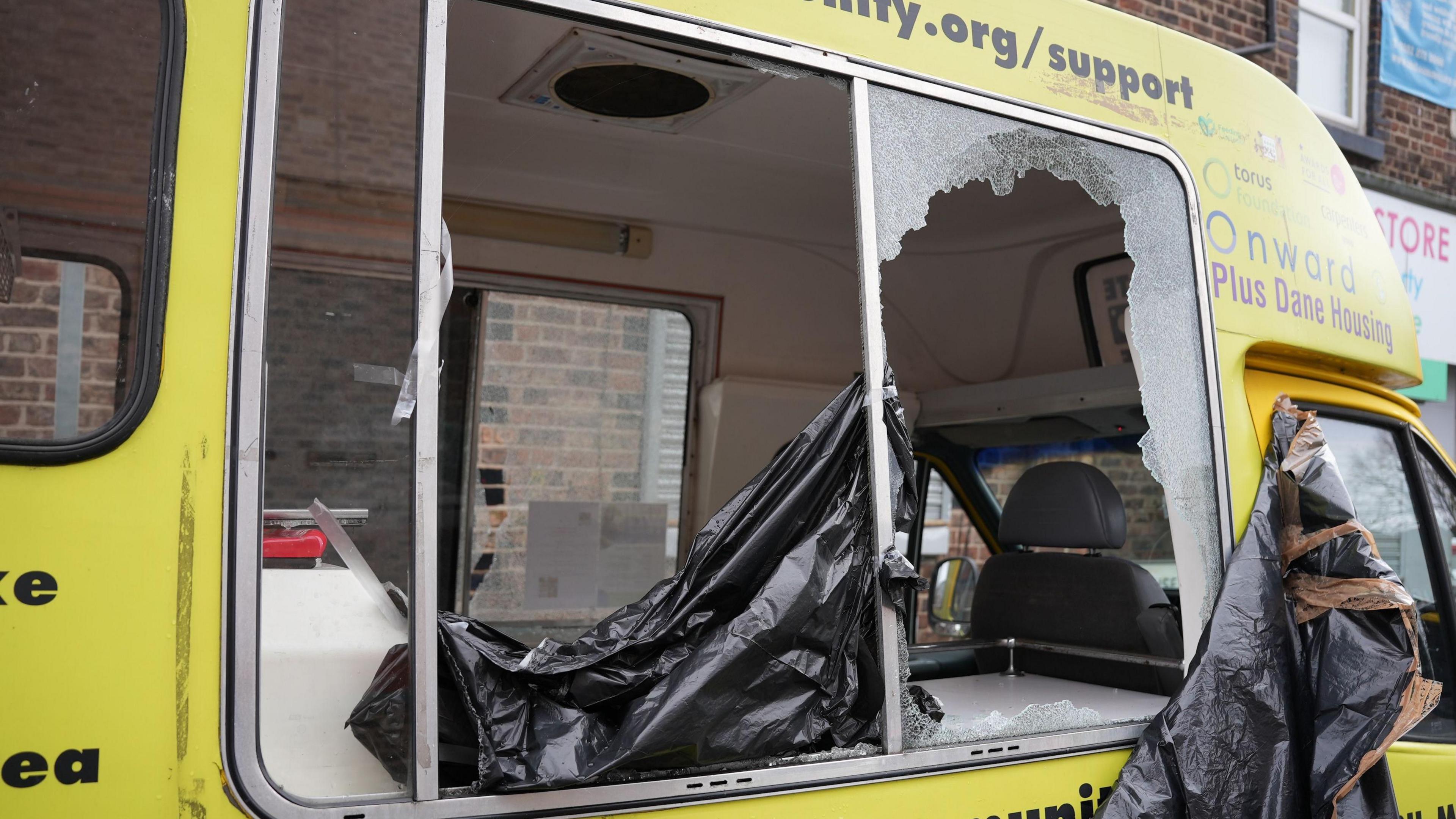 A close up picture of the damaged window, the window on the opposite side has also been smashed.