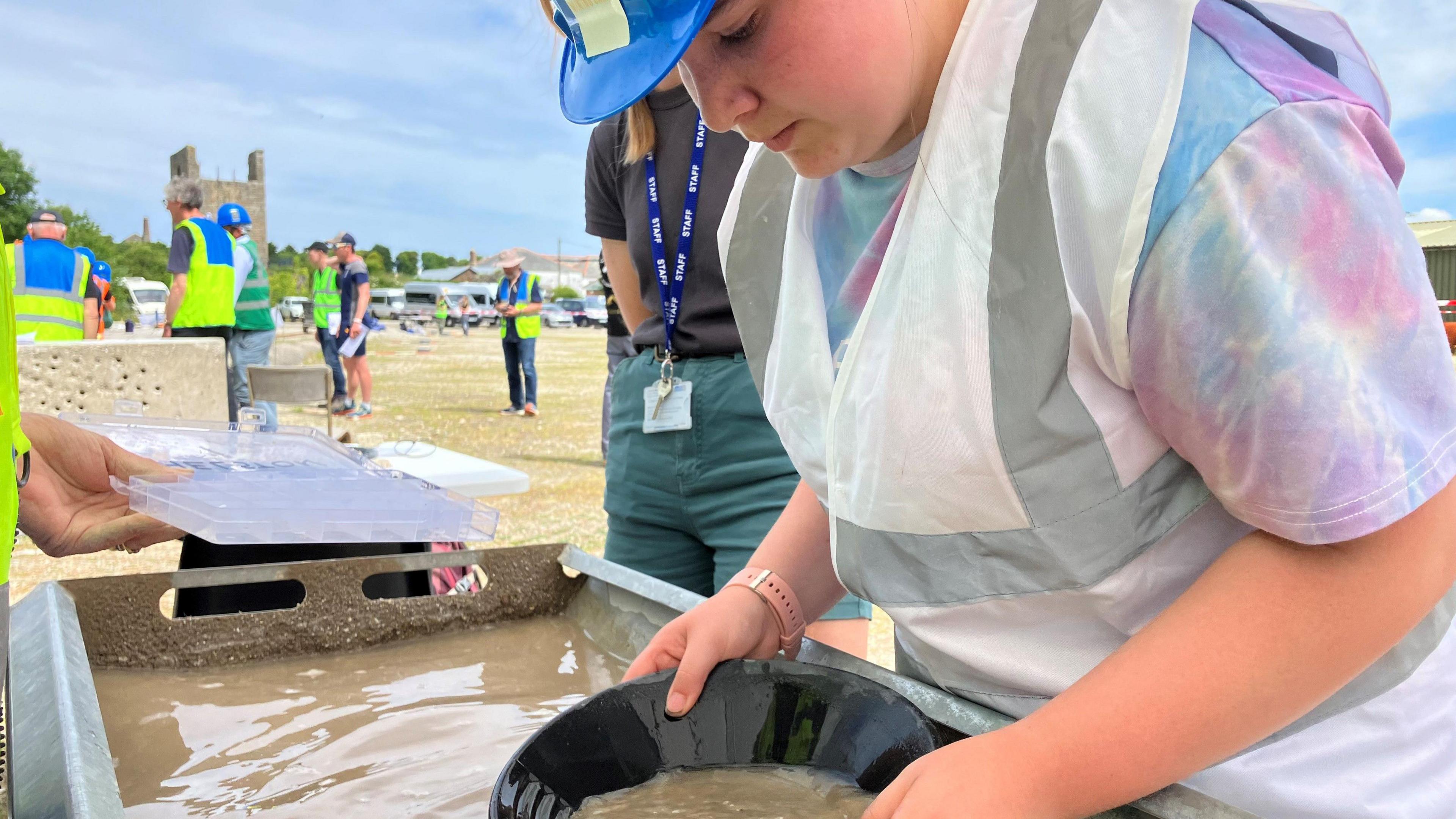 Girl panning sediment 