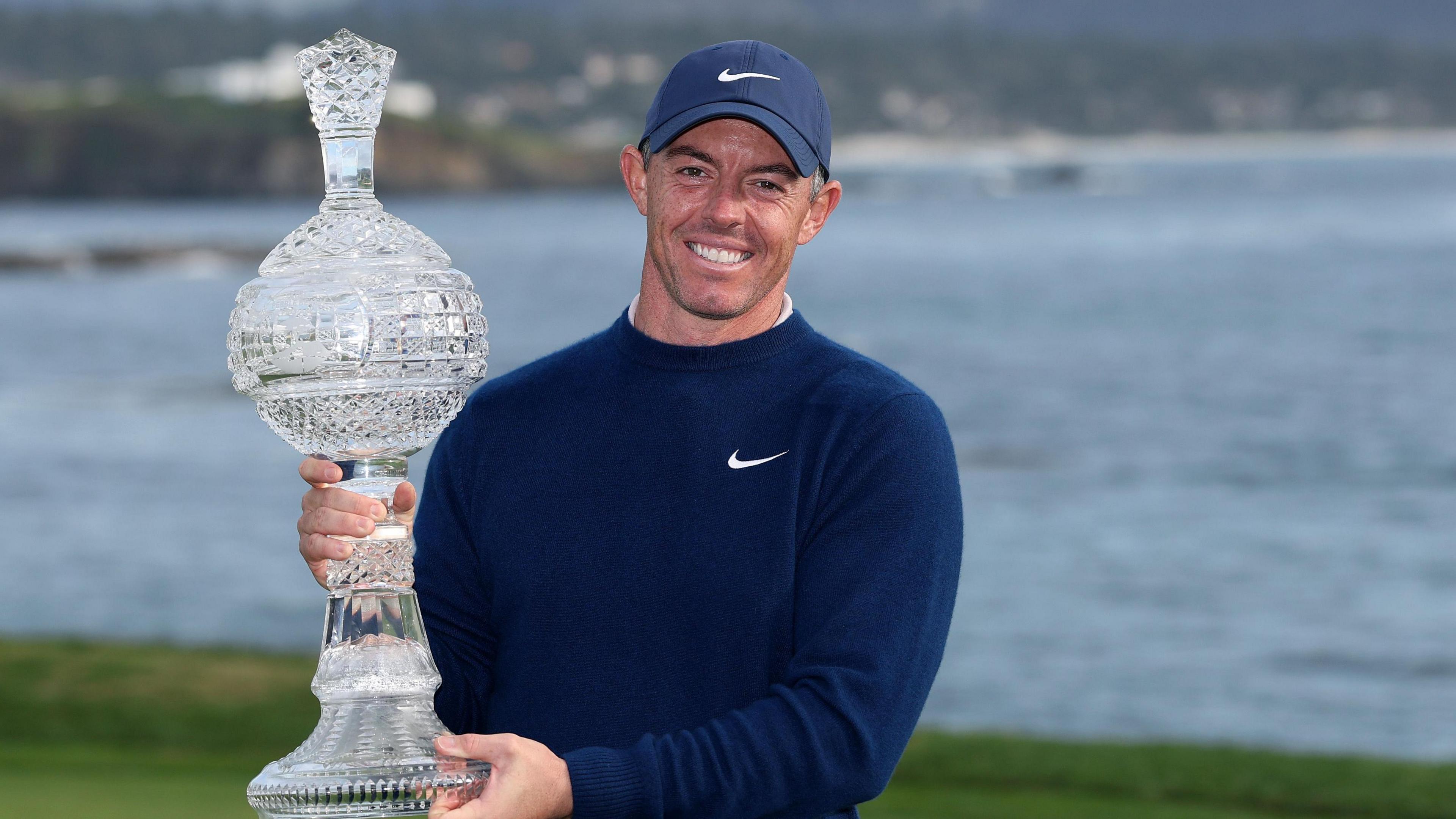 Rory McIlroy poses with the Pebble Beach Pro-Am trophy 