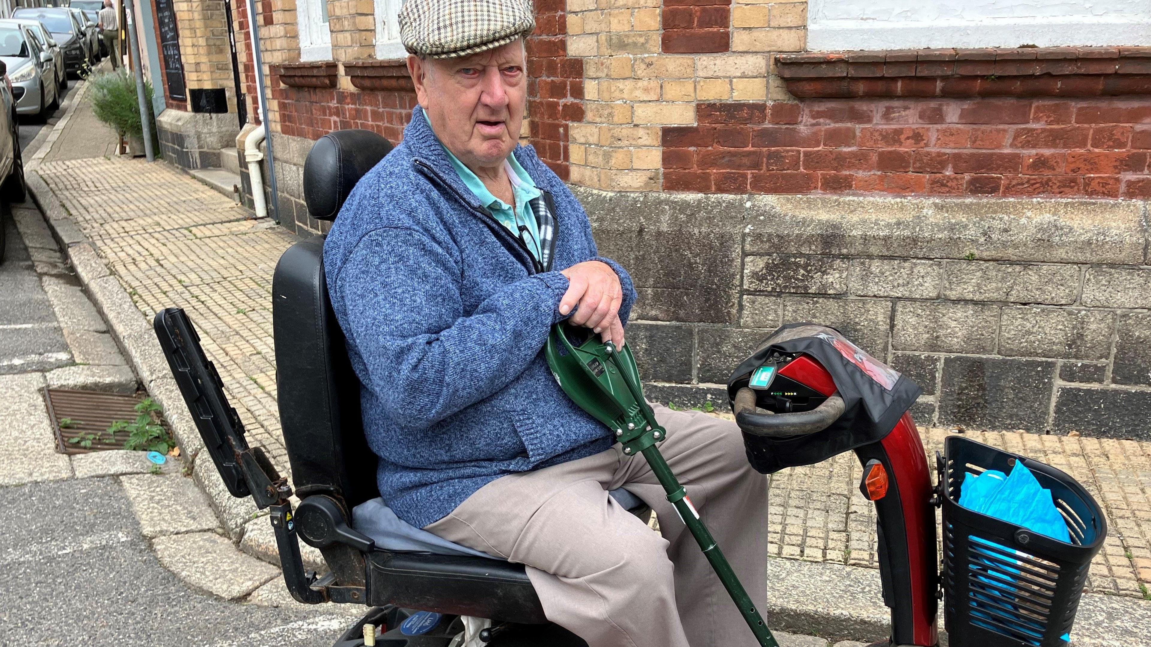 Man sitting in mobility scooter 