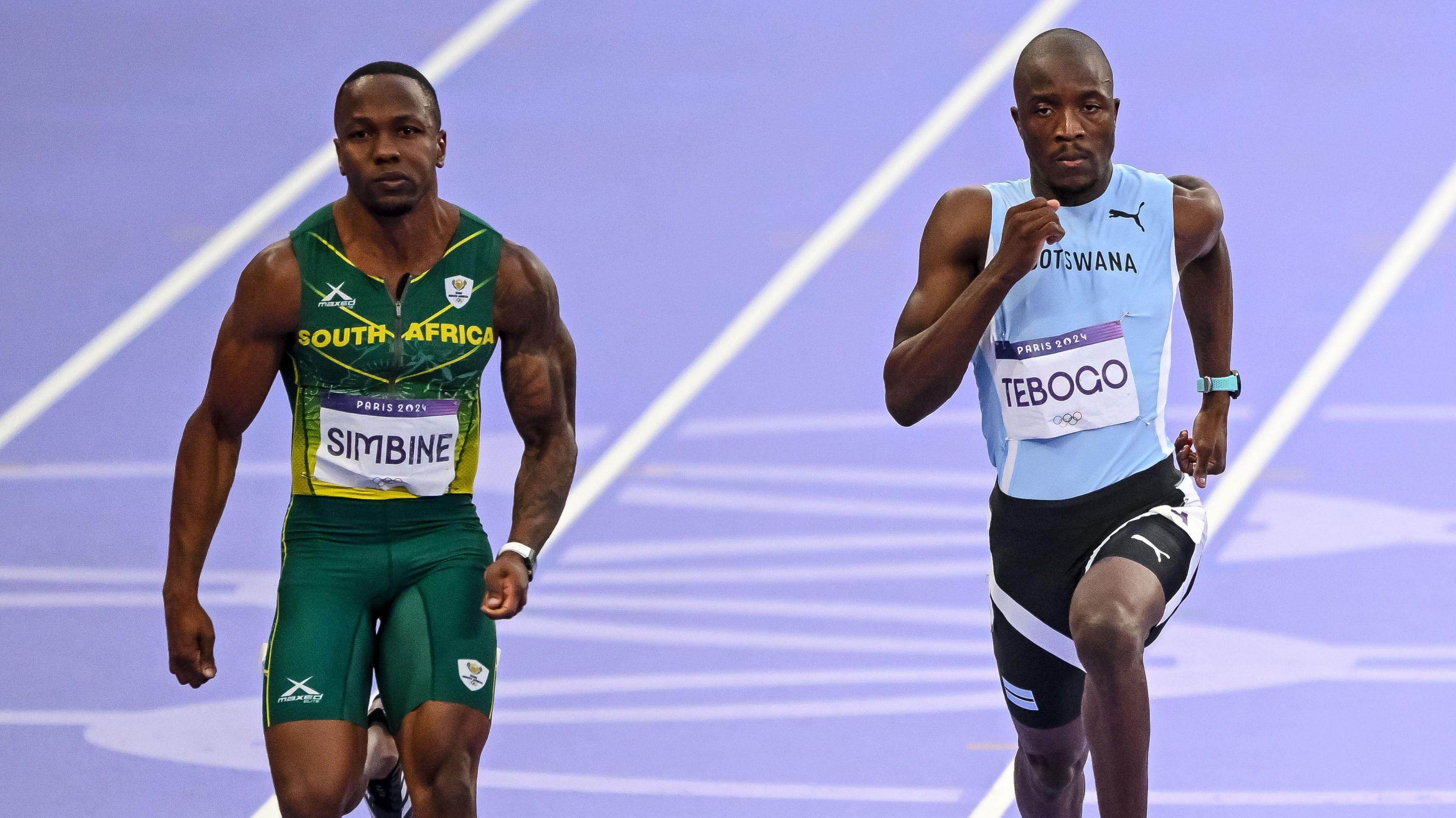South Africa's Akani Simbine in green and gold and Botswana's Letsile Tebogo in blue and black compete during the men's 100m semi-final on day nine of the Olympic Games Paris 2024