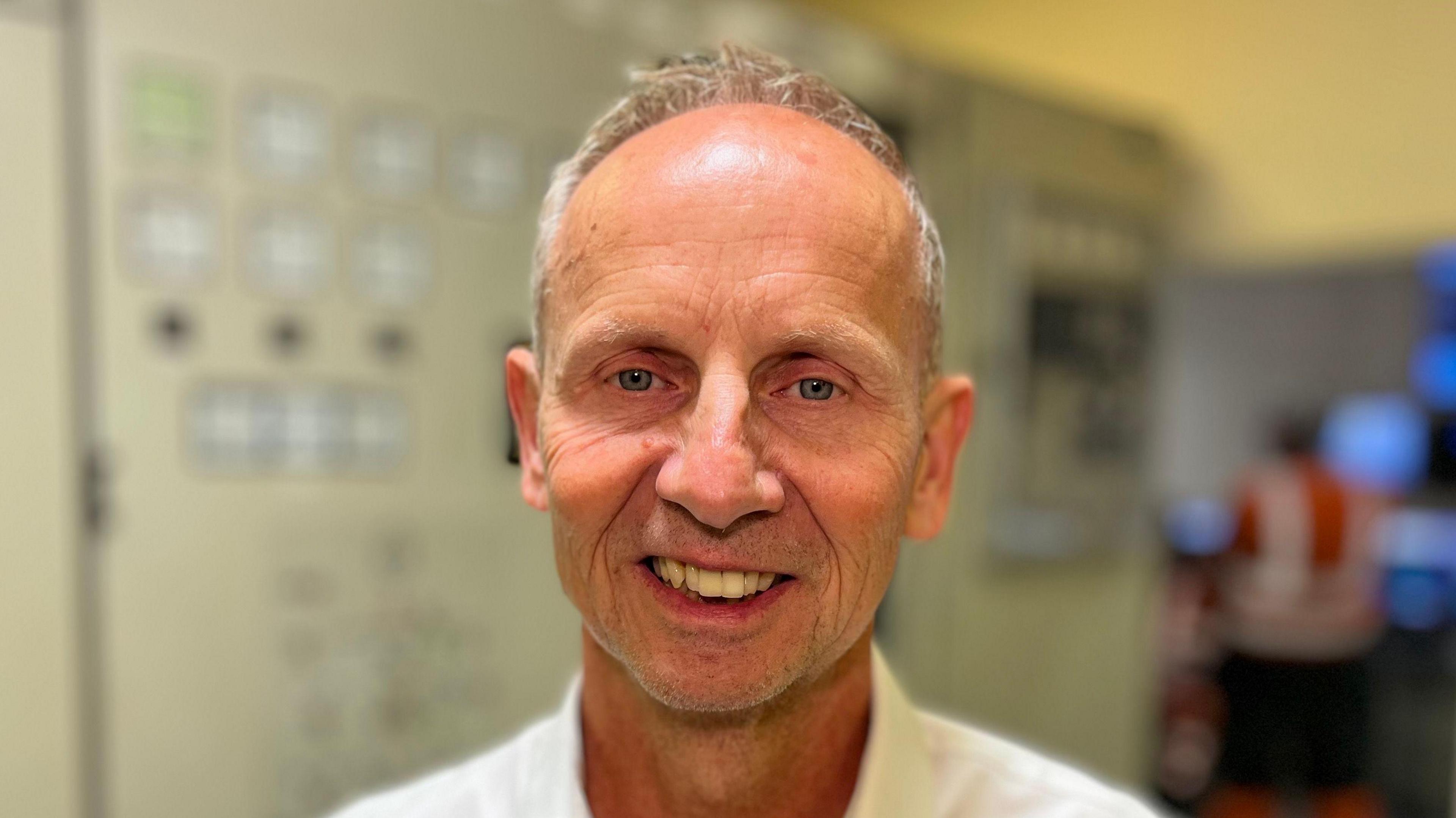 A head and shoulders image of Eddie Wilkinson. He is looking directly into the camera and smiling.