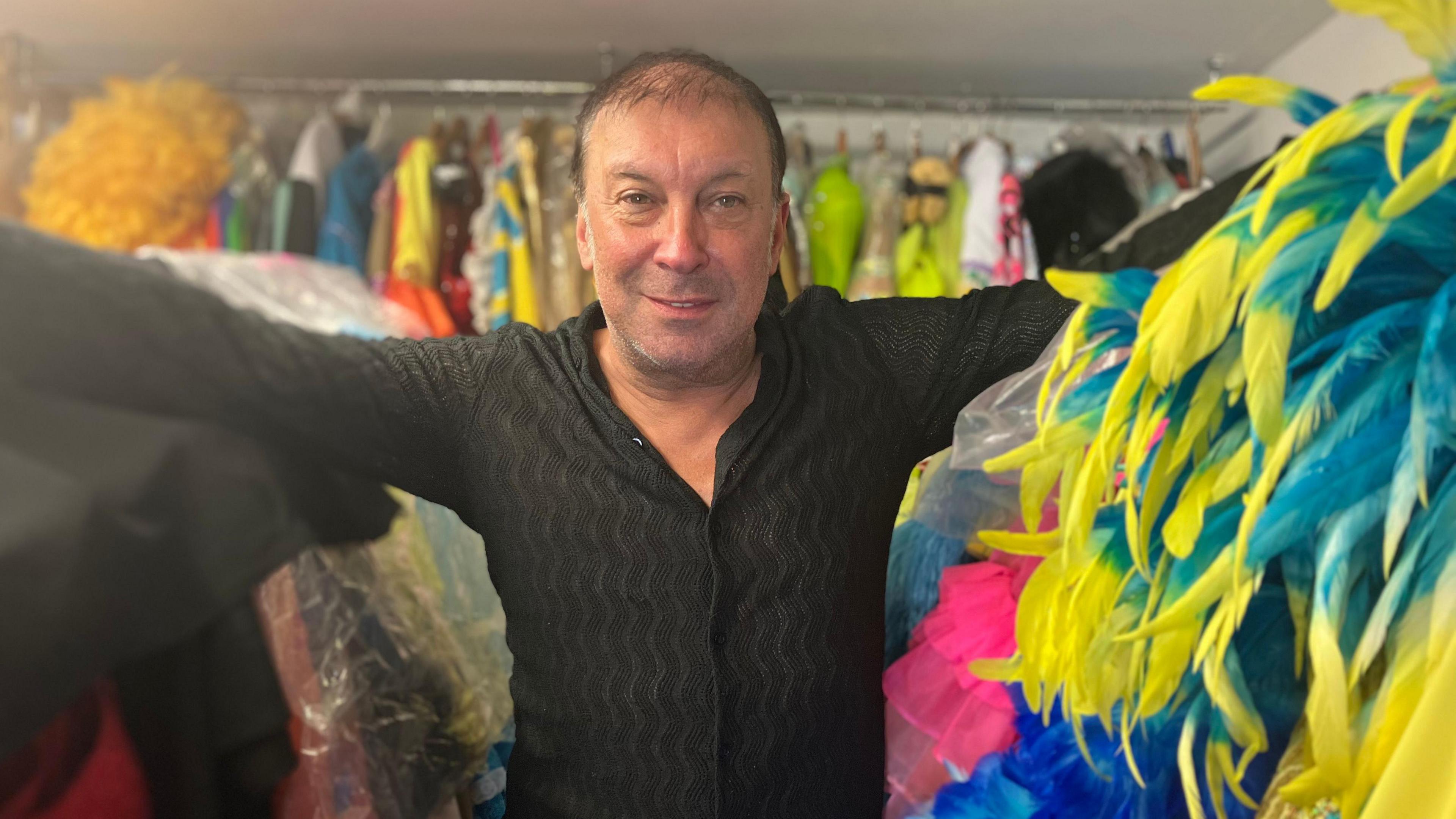 Ceri in the storage room for all his costumes at the bottom of his garden 