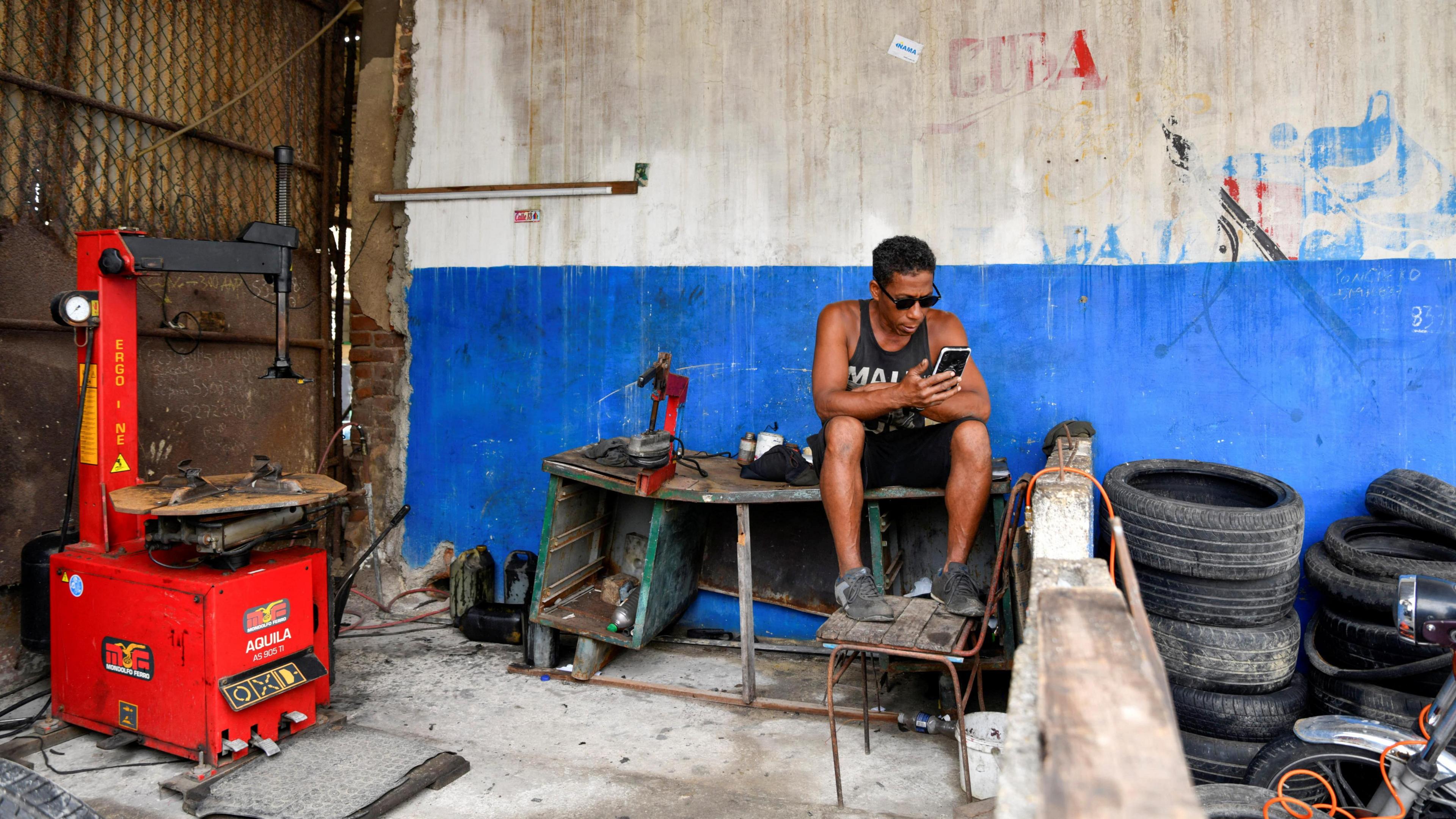 A man sits in a workshop as Cuba is hit by an island-wide blackout,