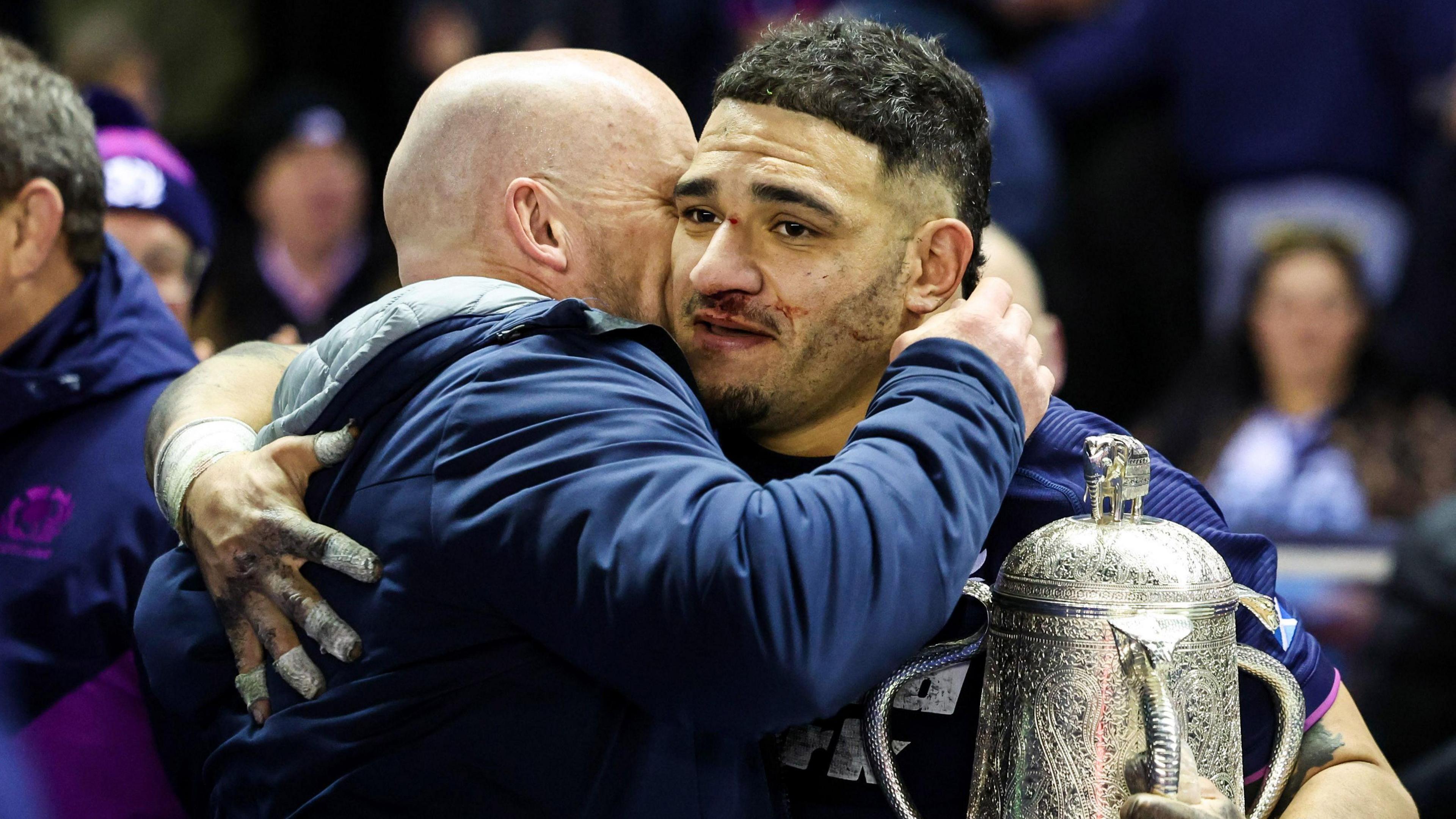 Scotland head coach Gregor Townsend embraces captain Sione Tuipulotu after their win over England