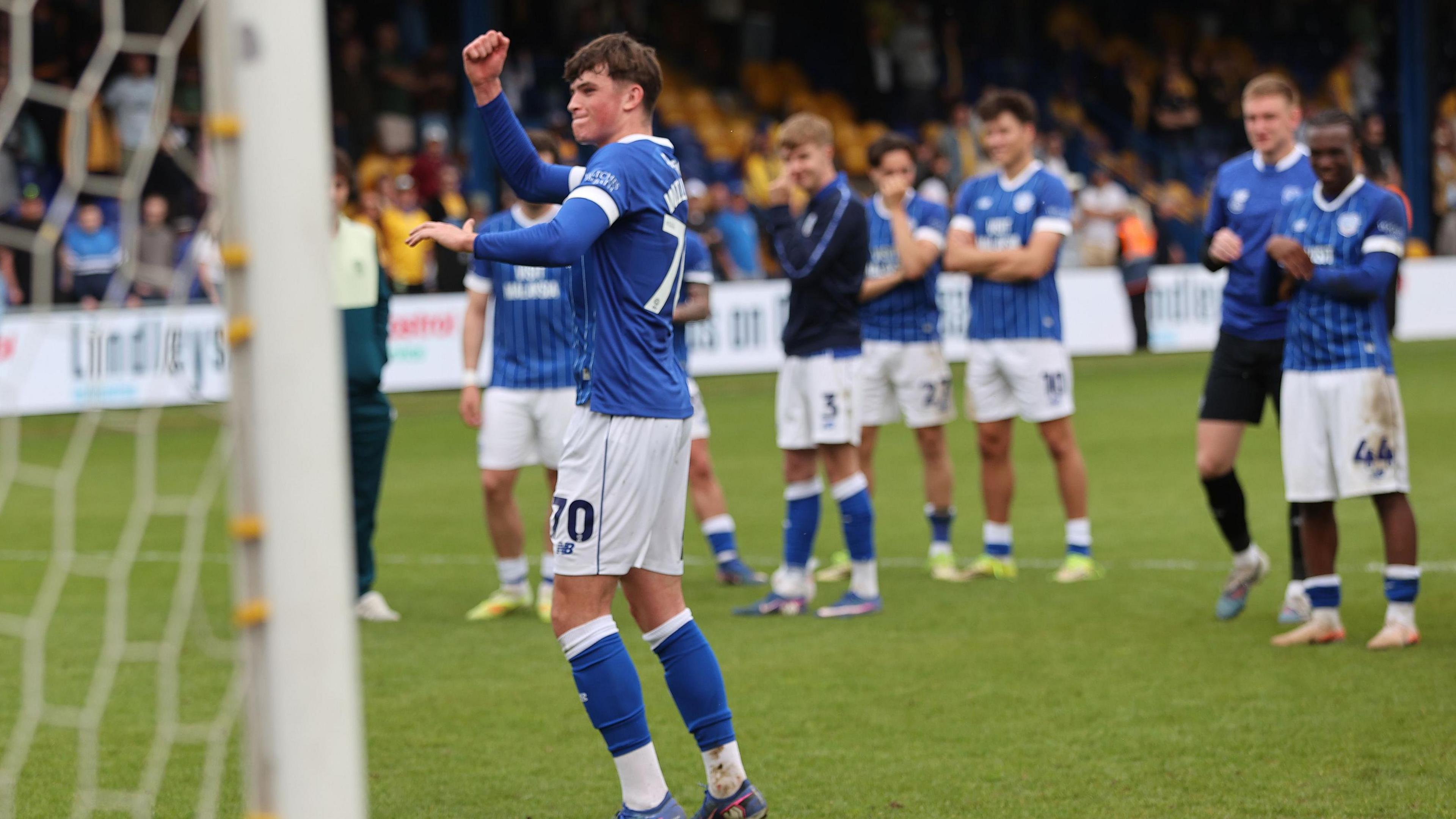 Noah Williams celebrates in front of Cardiff City fans