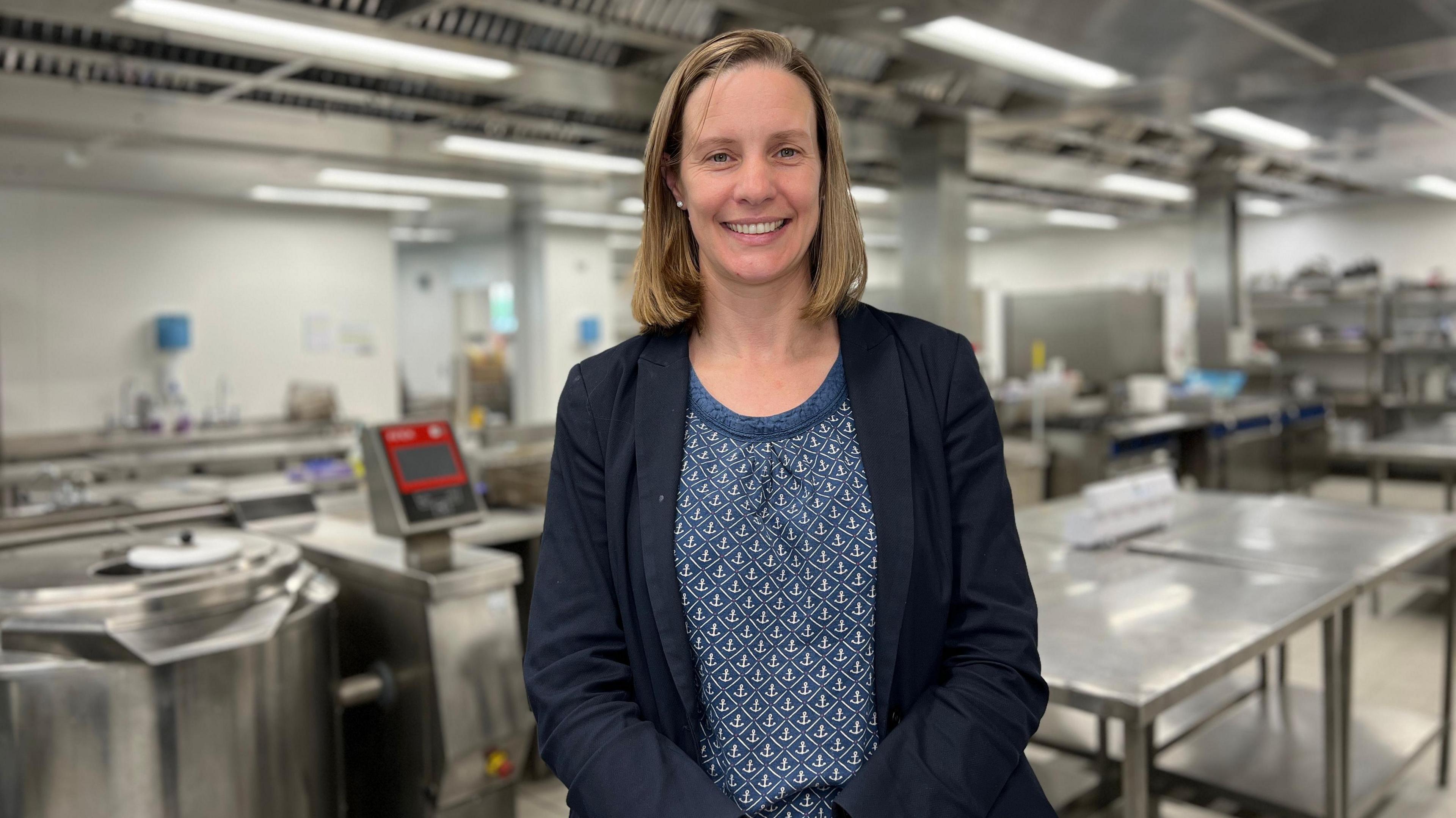 Susie Richardson in a prison kitchen, smiling at the camera