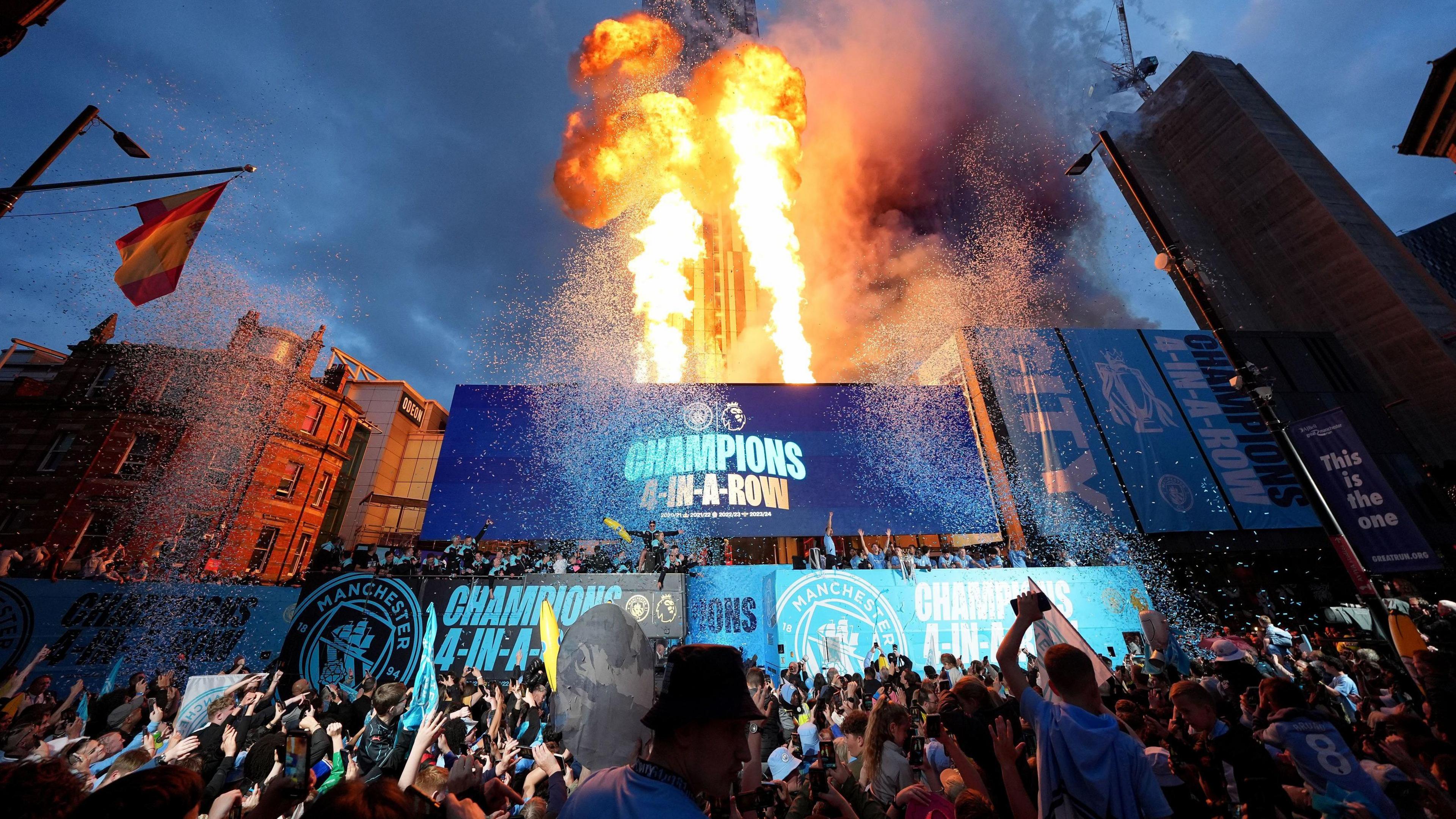 Pyrotechnics as Manchester City players, staff and fans celebrate during a trophy parade in Manchester