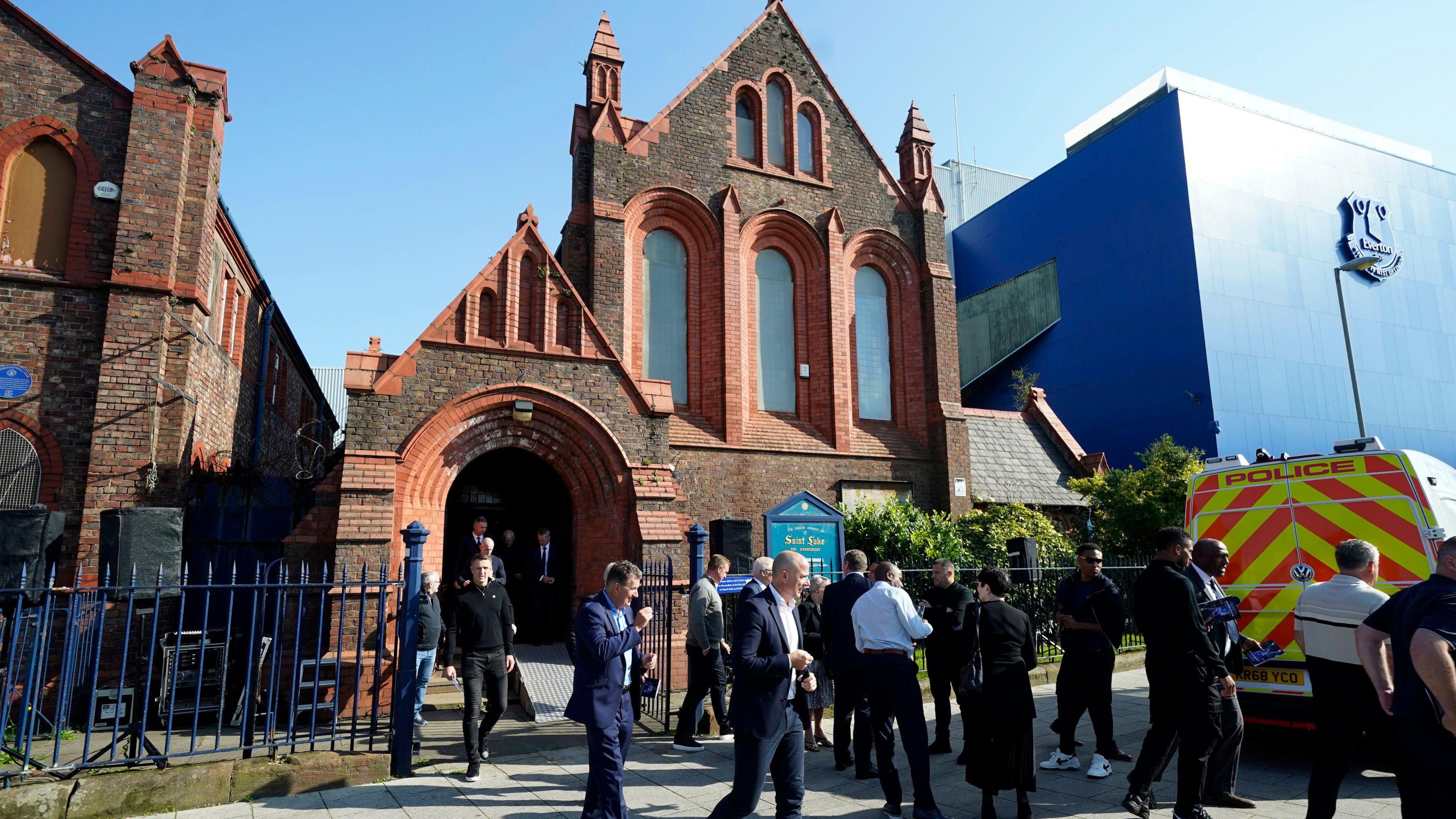 Mourners leave the service 