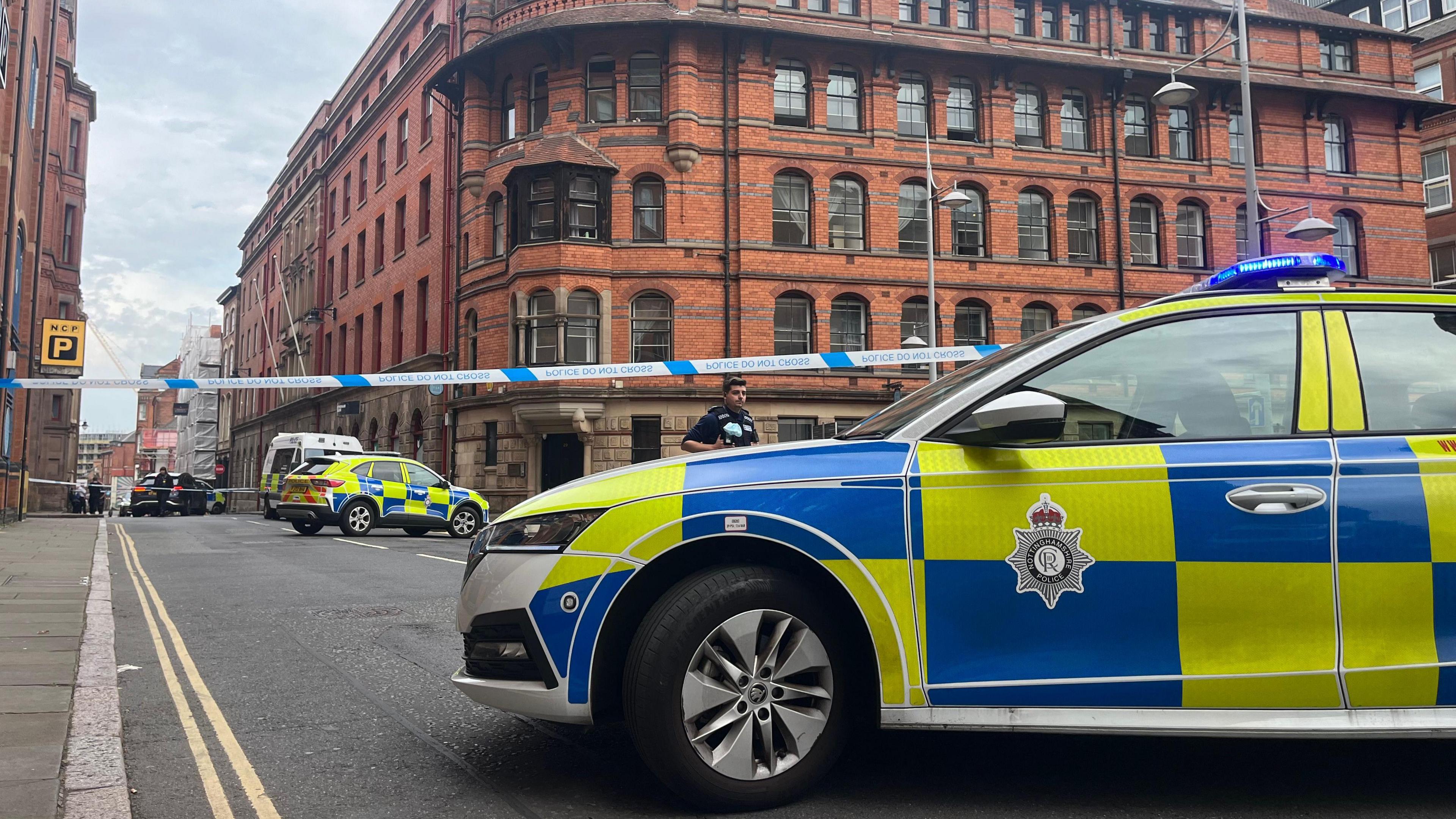 Police vehicles and police tape in Barker Gate