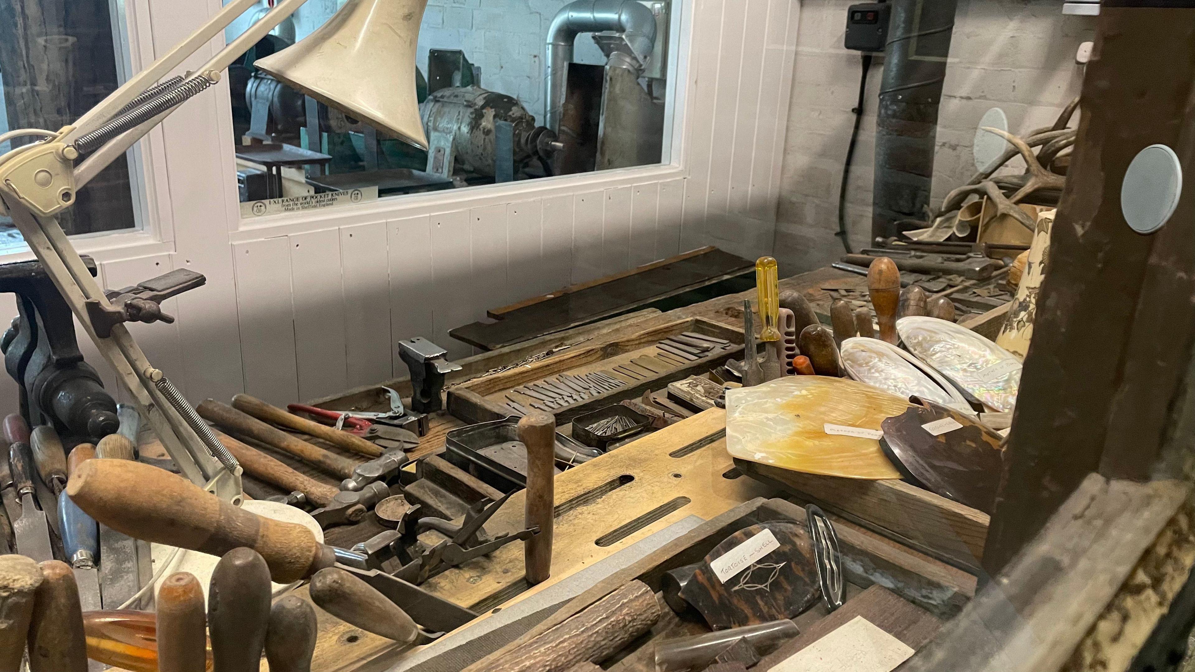 Mr Shaw's workshop, with a table filled with different types of tools including chisels and hammers.