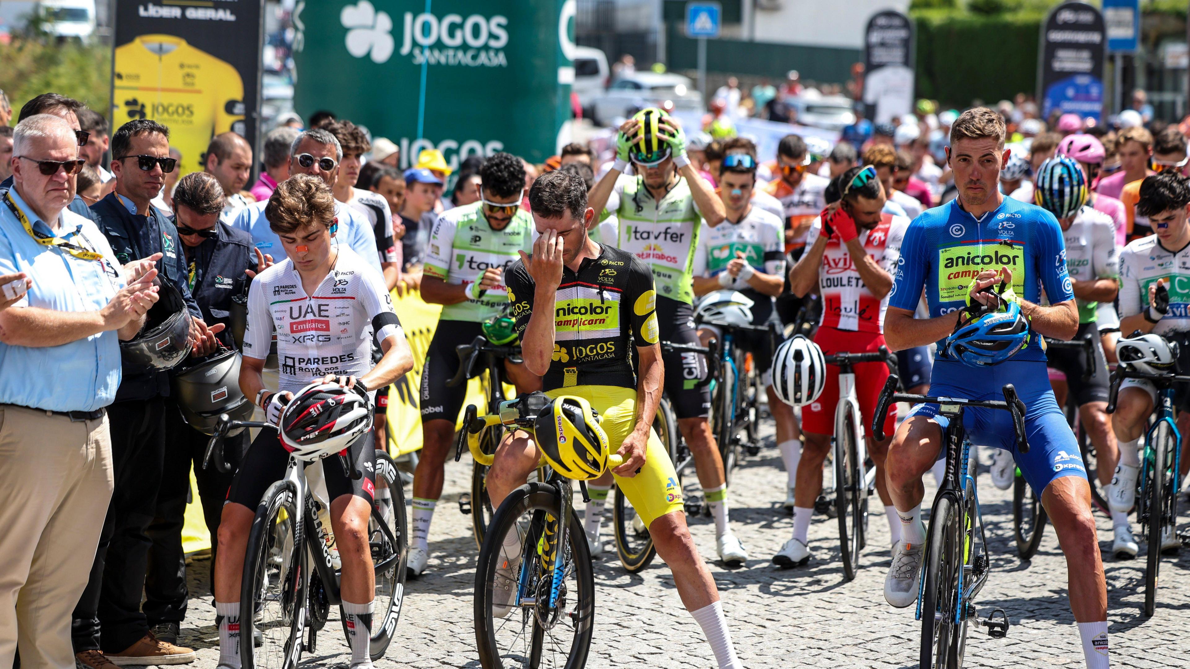 Cyclists sit stationary on their bicycles