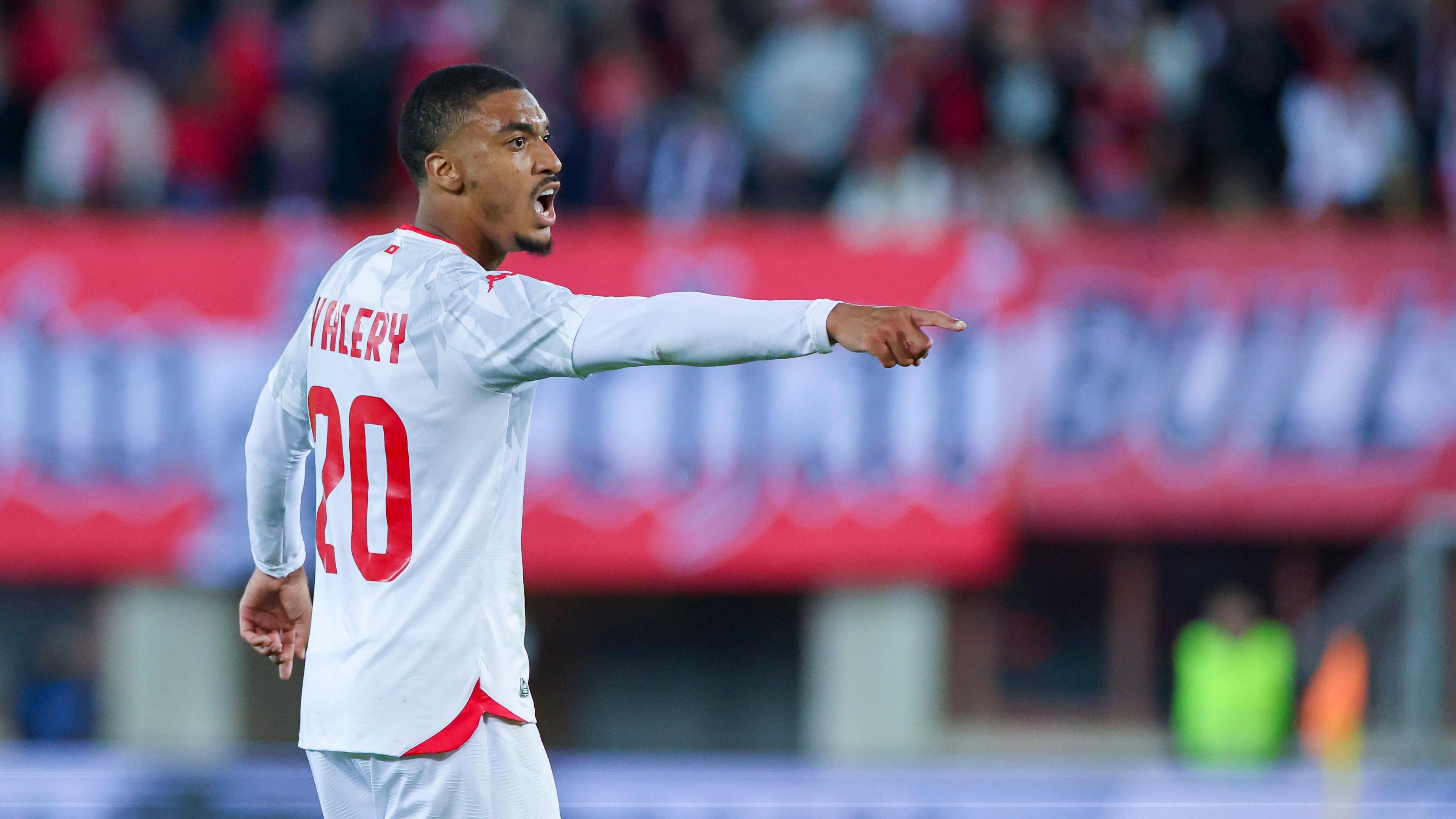Yan Valery, wearing Tunisia's white kit with red accents, shouting directions during their match with Austria on 1 June