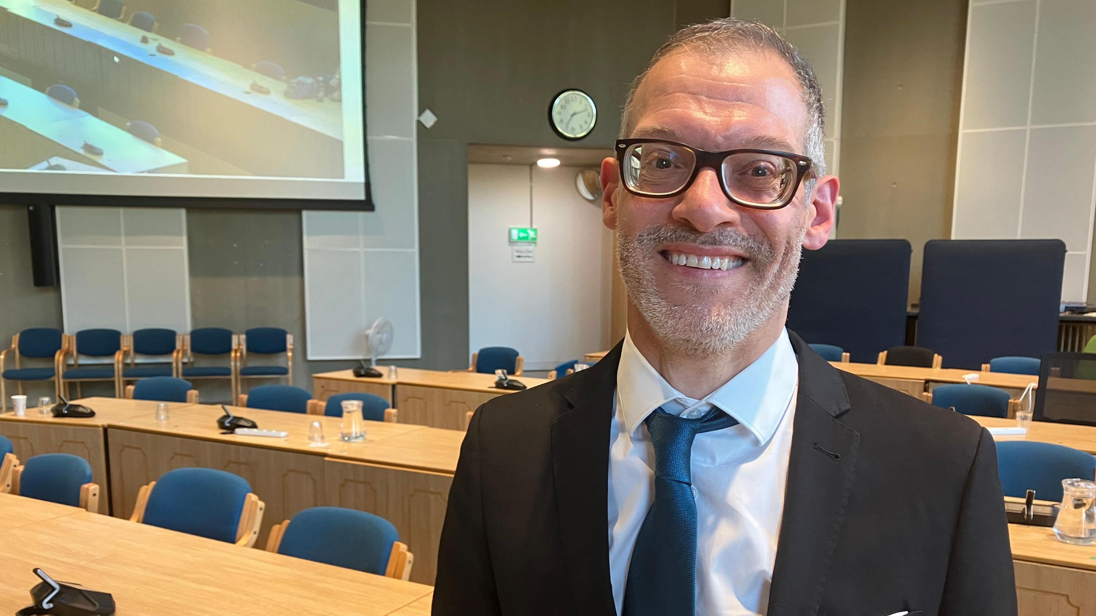 A picture of Central Bedfordshire Council Leader Adam Zerny, with a black suit jacket on and a sea blue tie