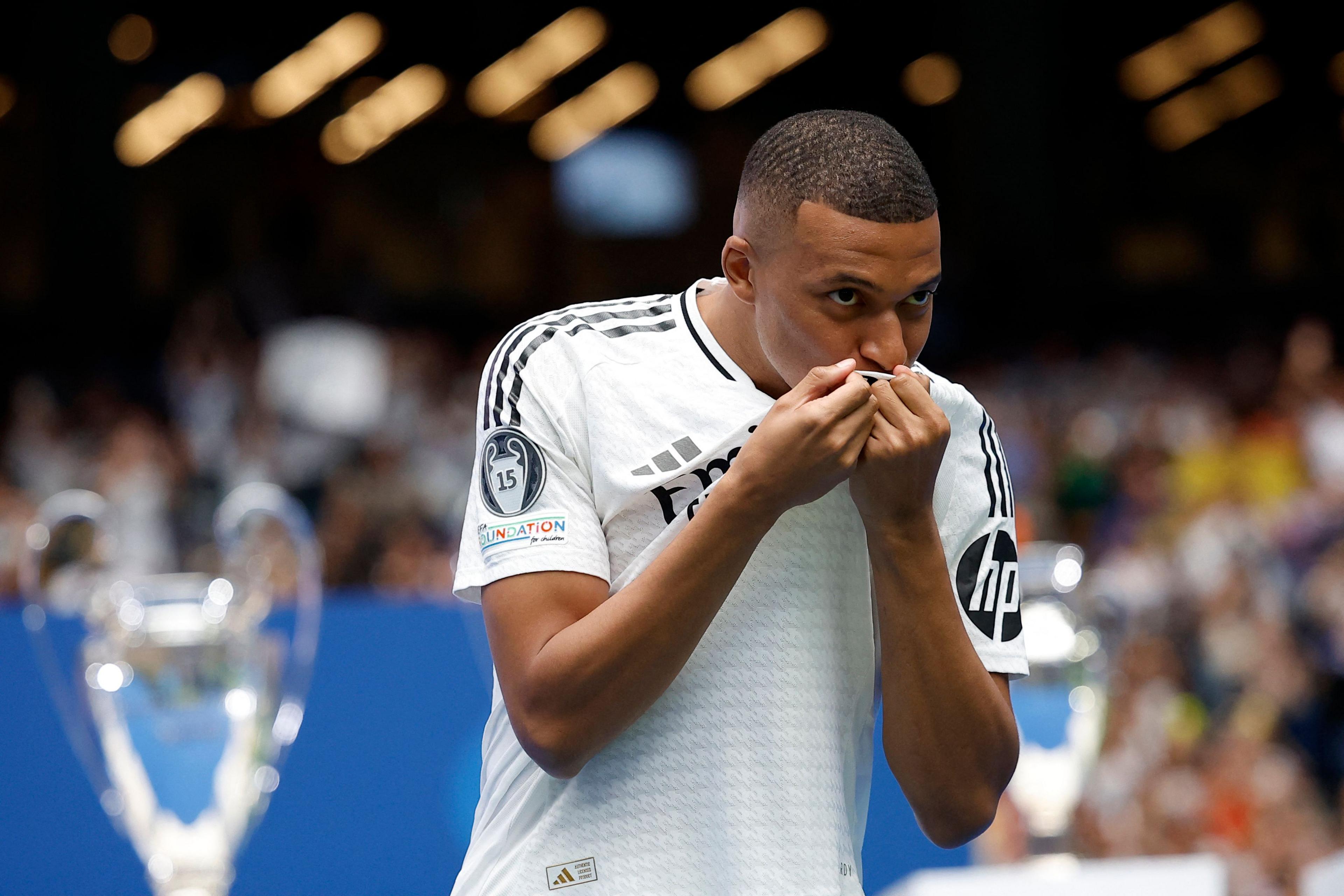 Mbappe kissing Real Madrid shirt