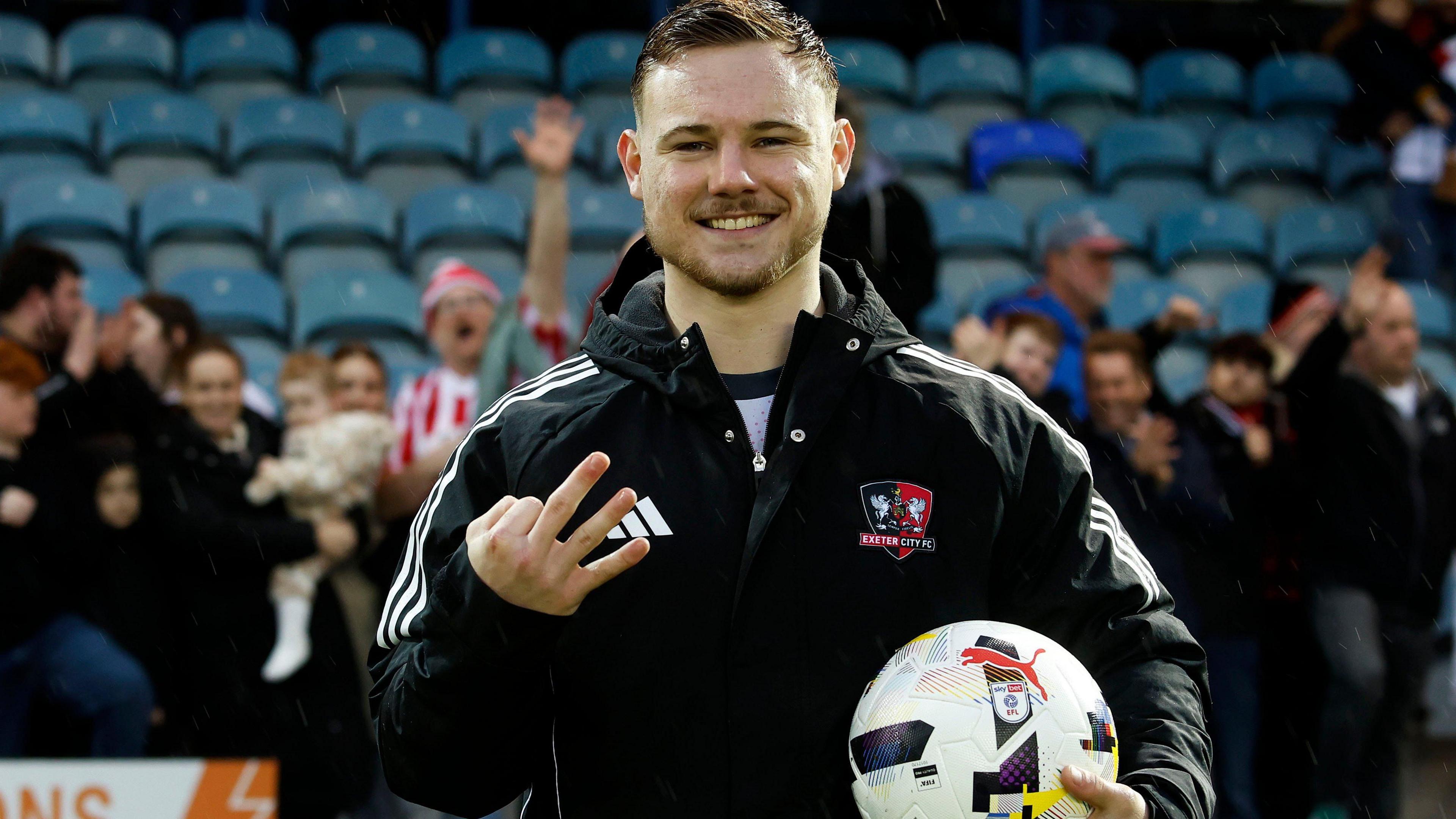 Jayden Wareham poses with the match ball after scoring his hat-trick