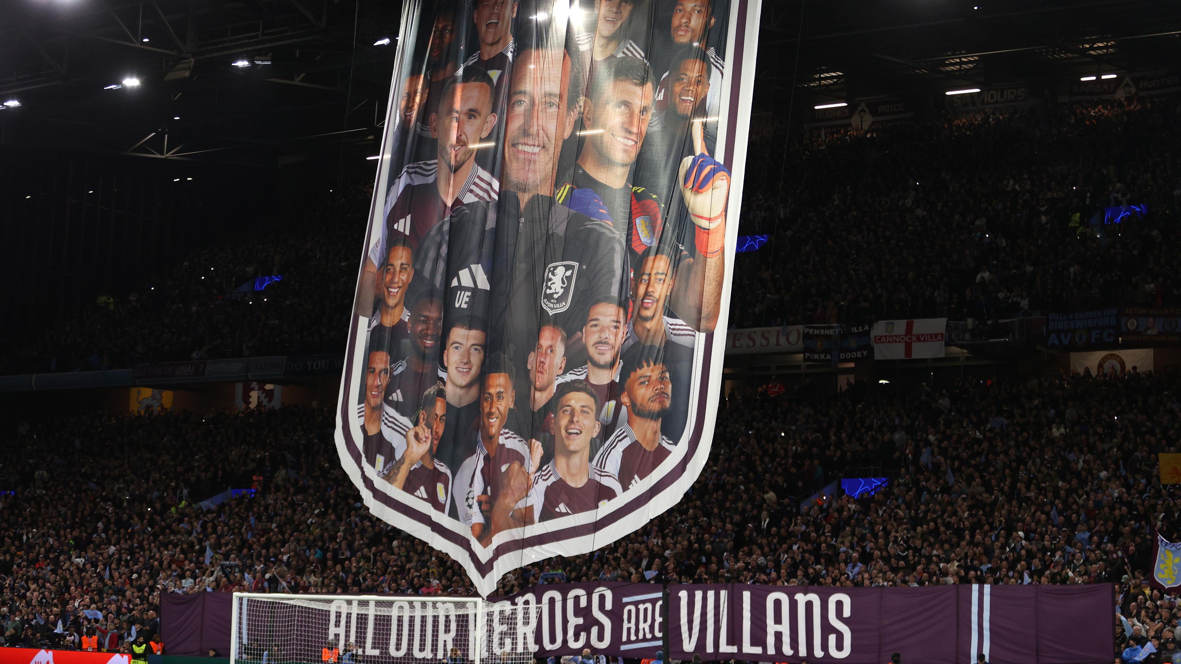 Aston Villa fans display a banner containing the faces of players and manager Unai Emery