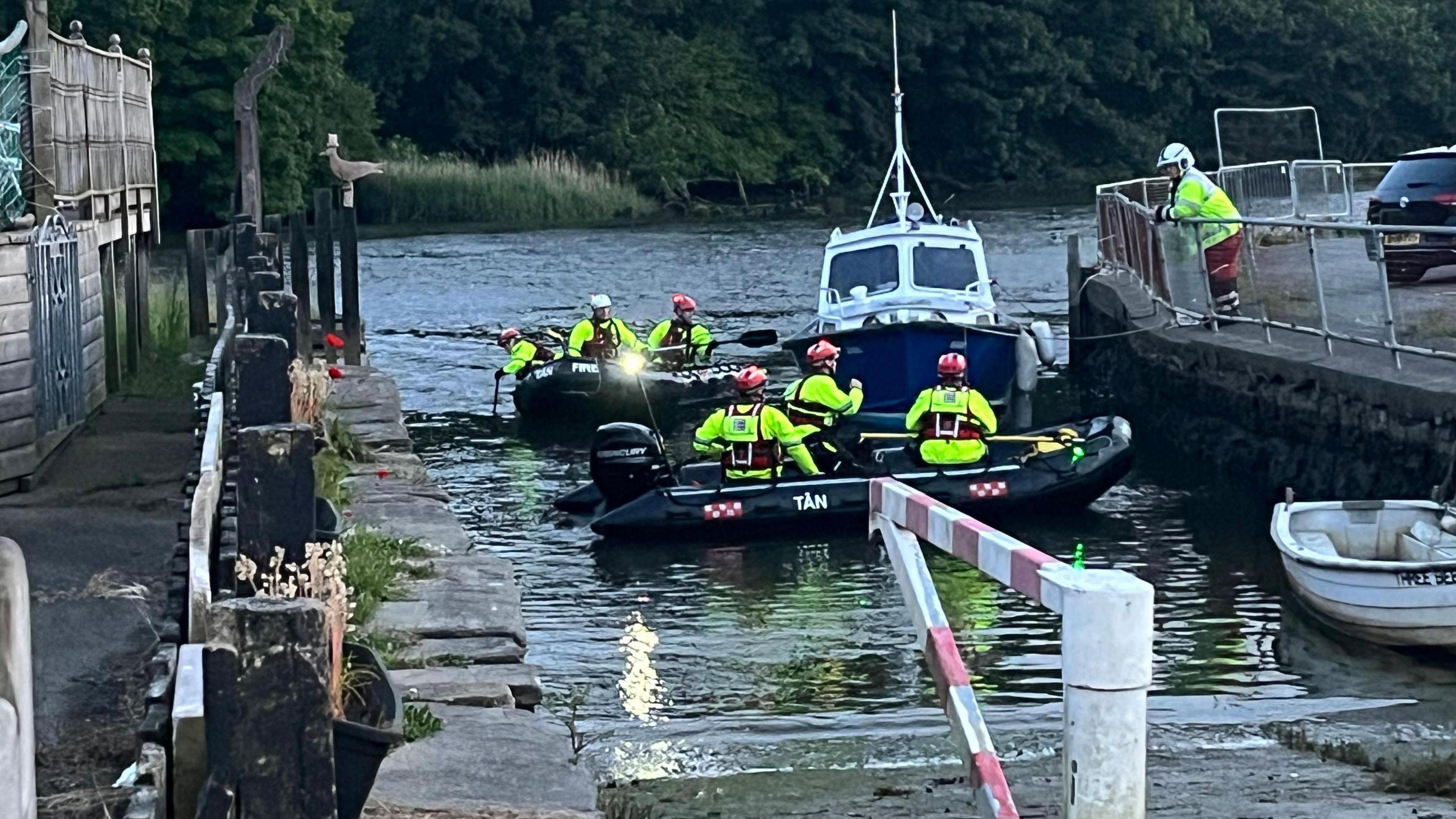 Coastguard boats and rescuers getting ready for their river search last night at the river slip