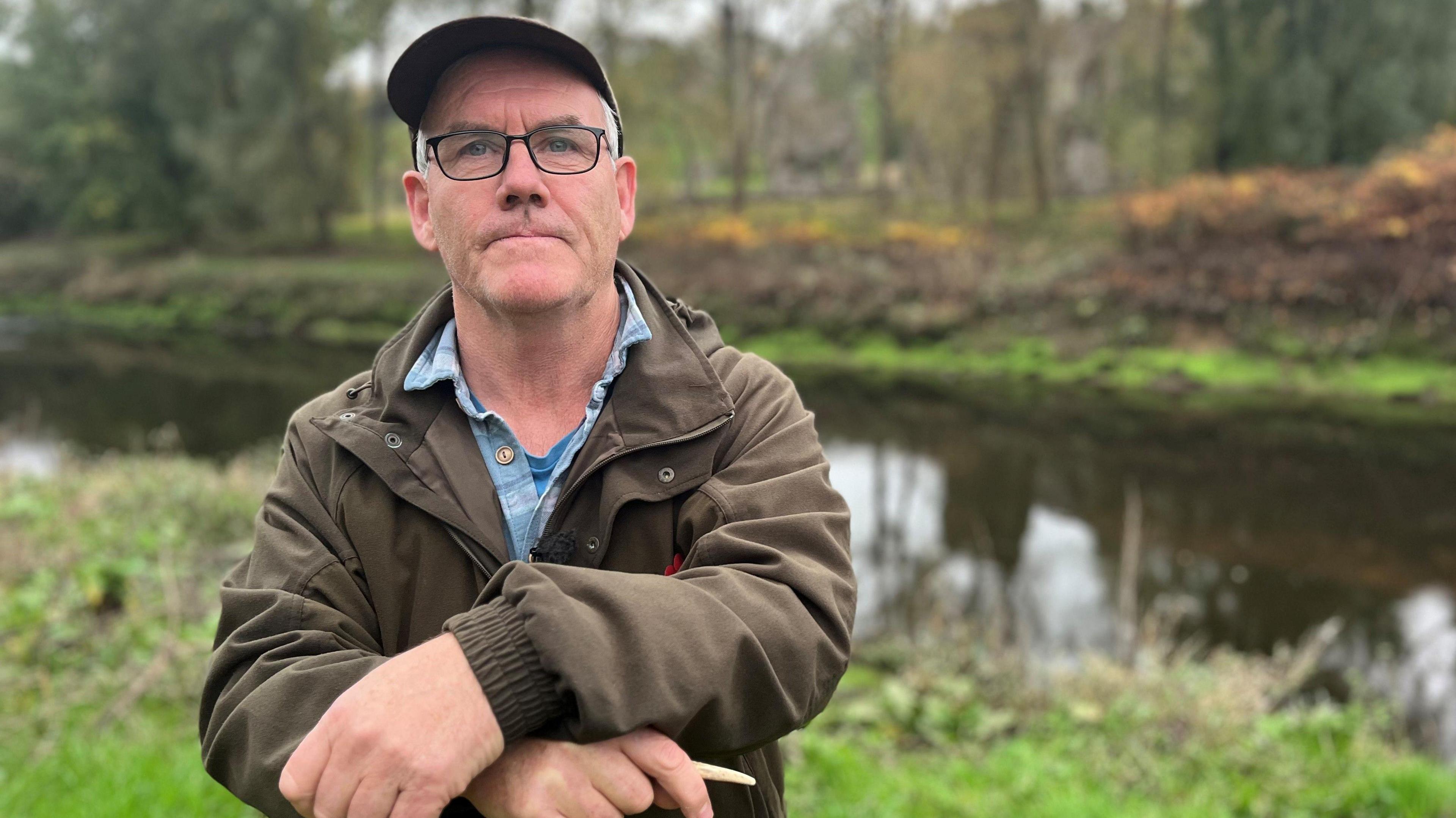 Simon Walters, a clean water campaigner, on the riverbank near the water