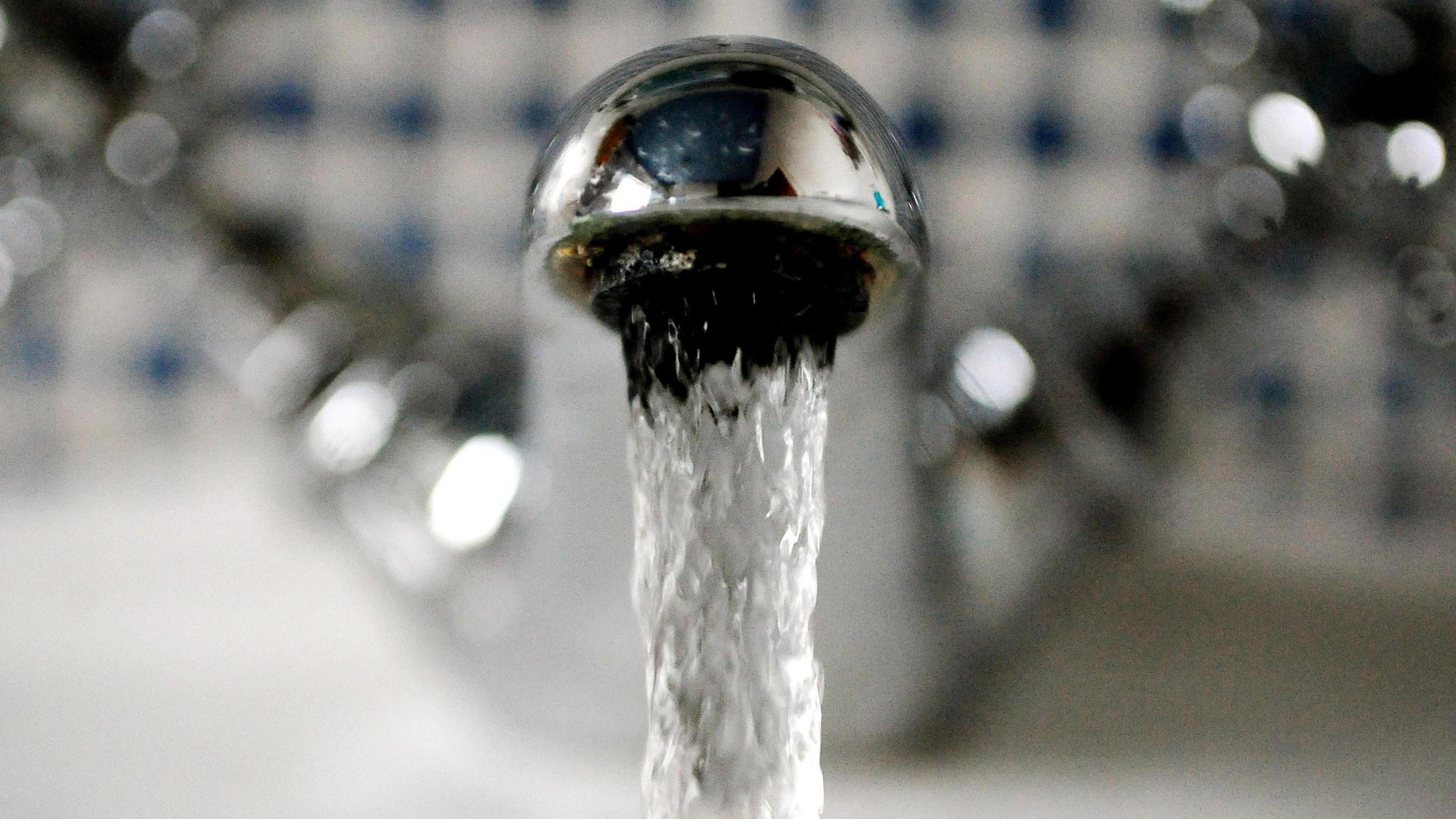 A close up of a tap with running water