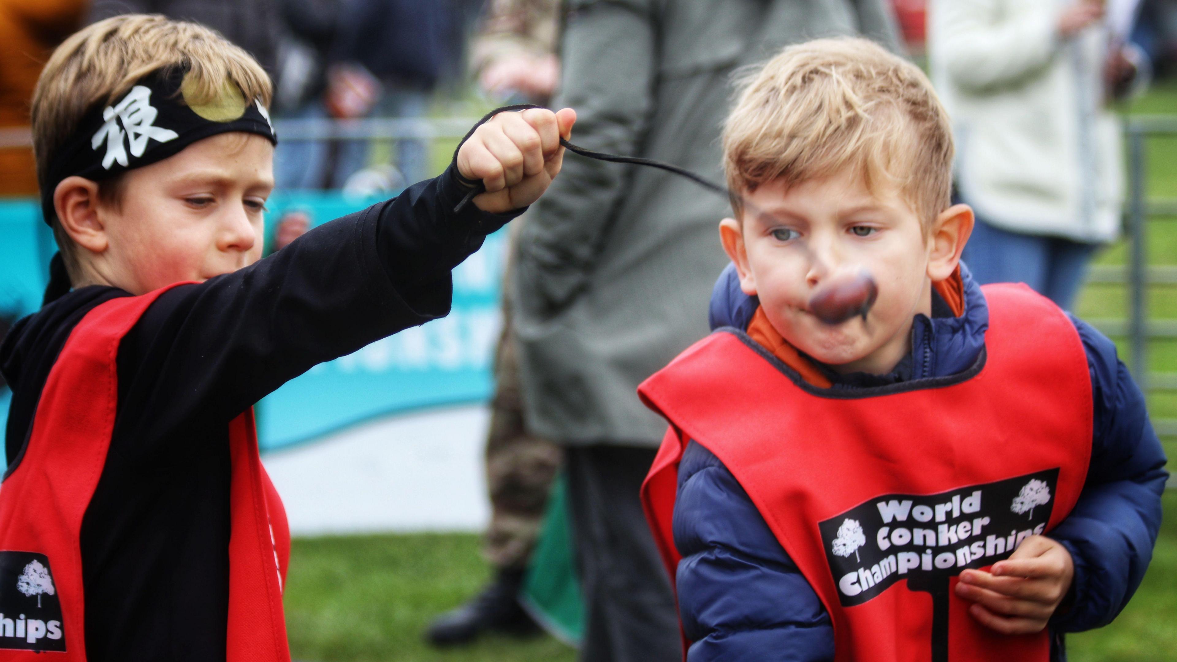 Two boys playing conkers.