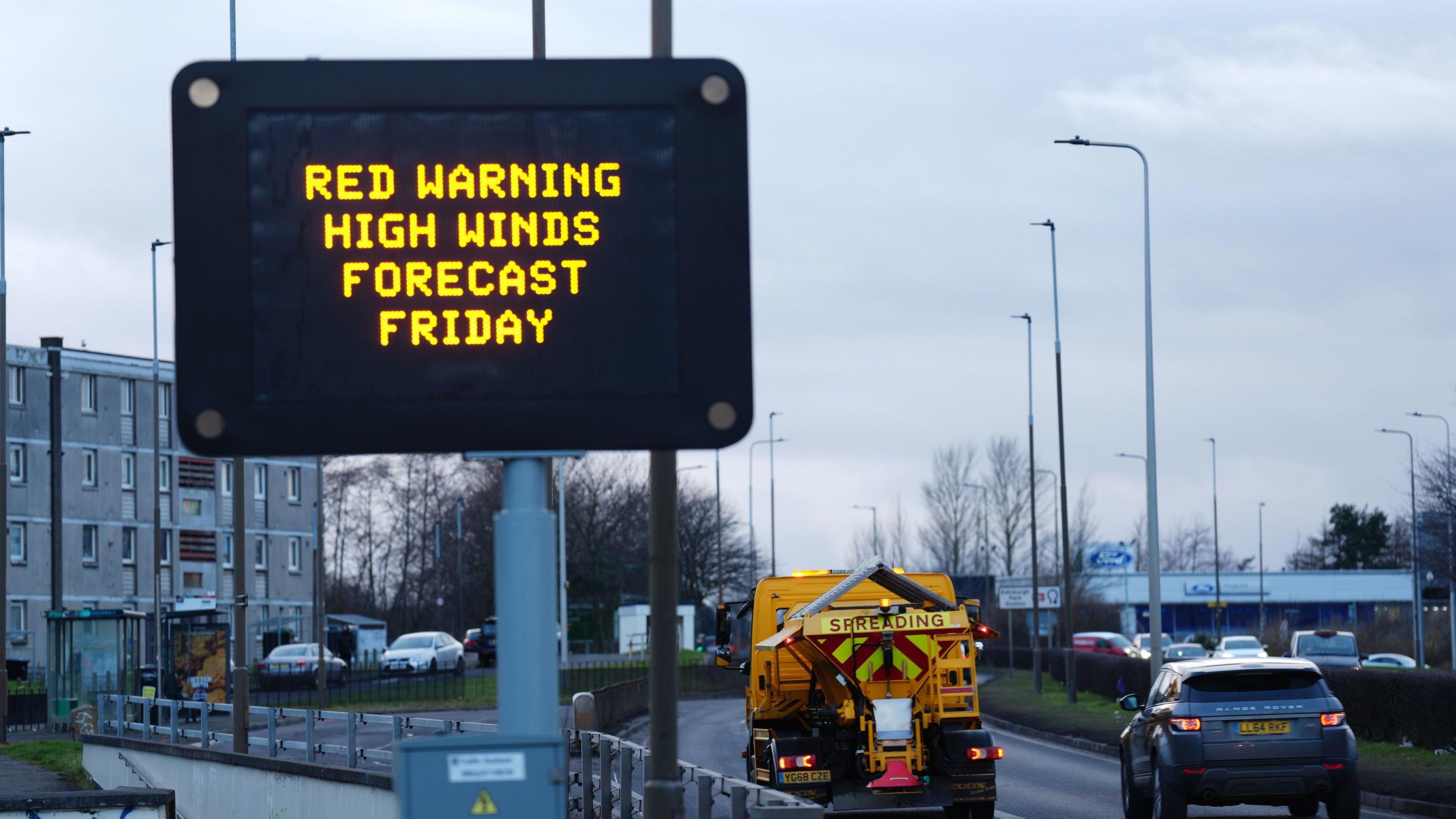 Road sign reading red warning high winds forecast Friday