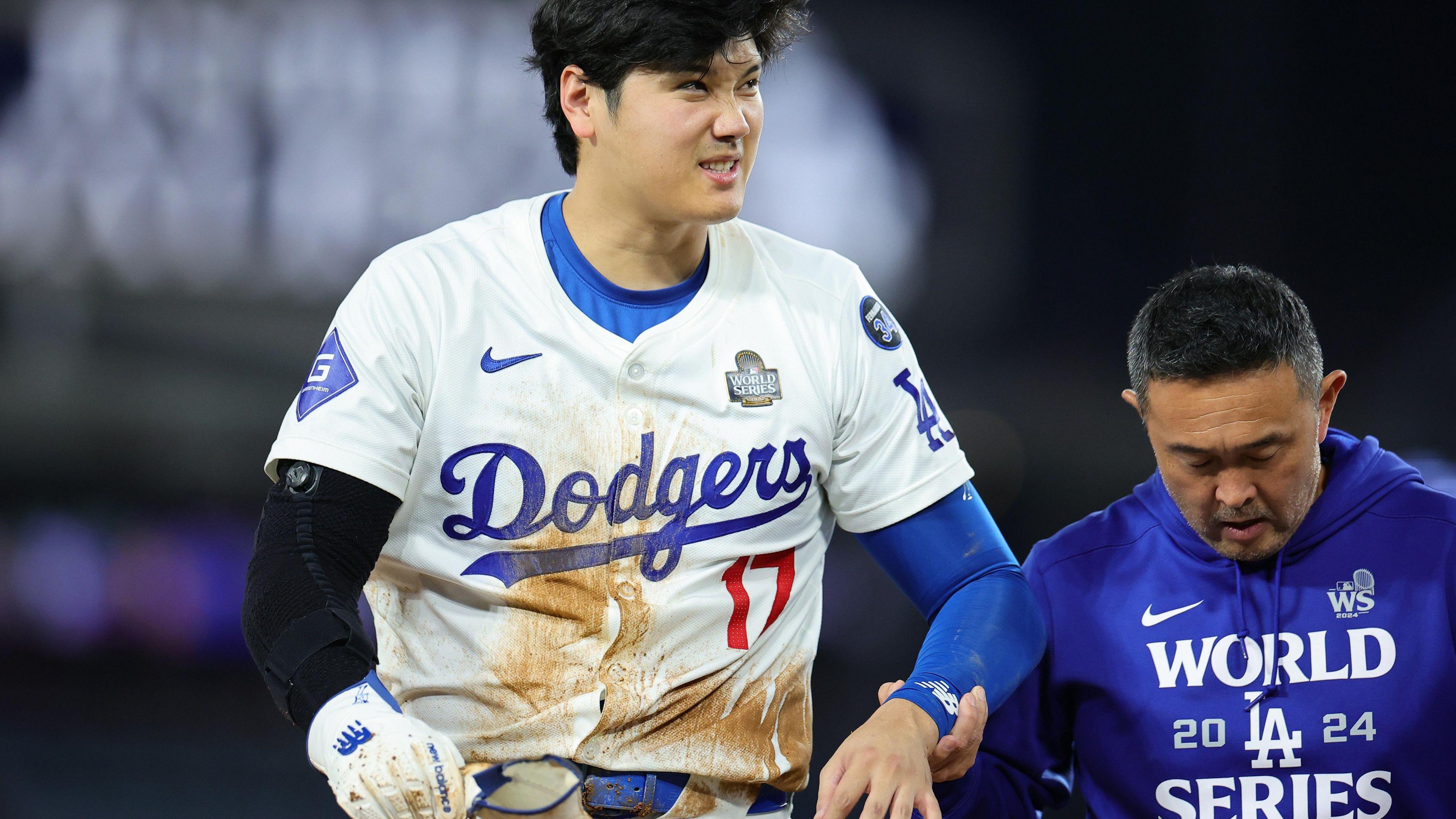 Shohei Ohtani is escorted from the field with a shoulder injury