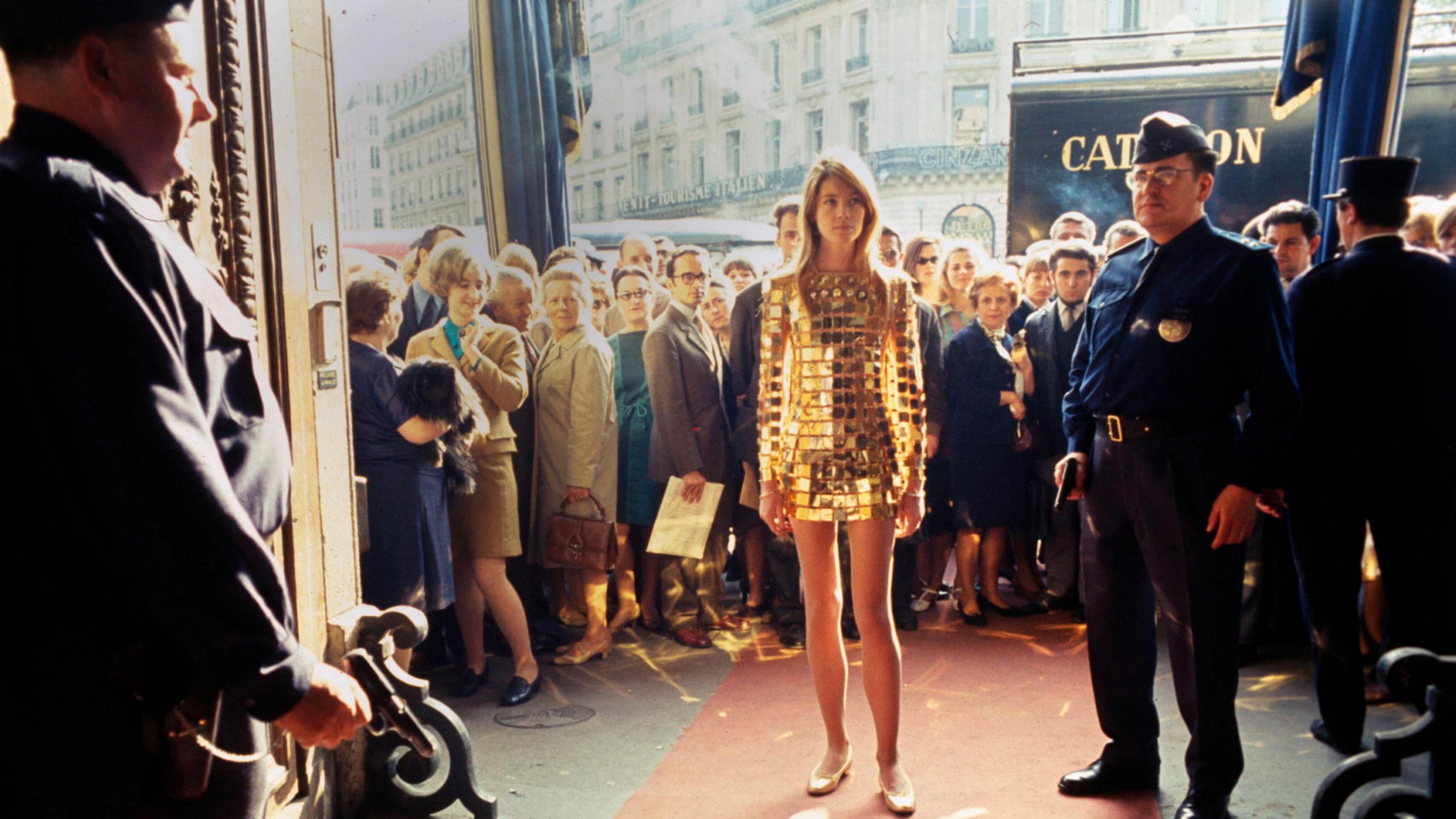 Francoise Hardy wears a gold dress