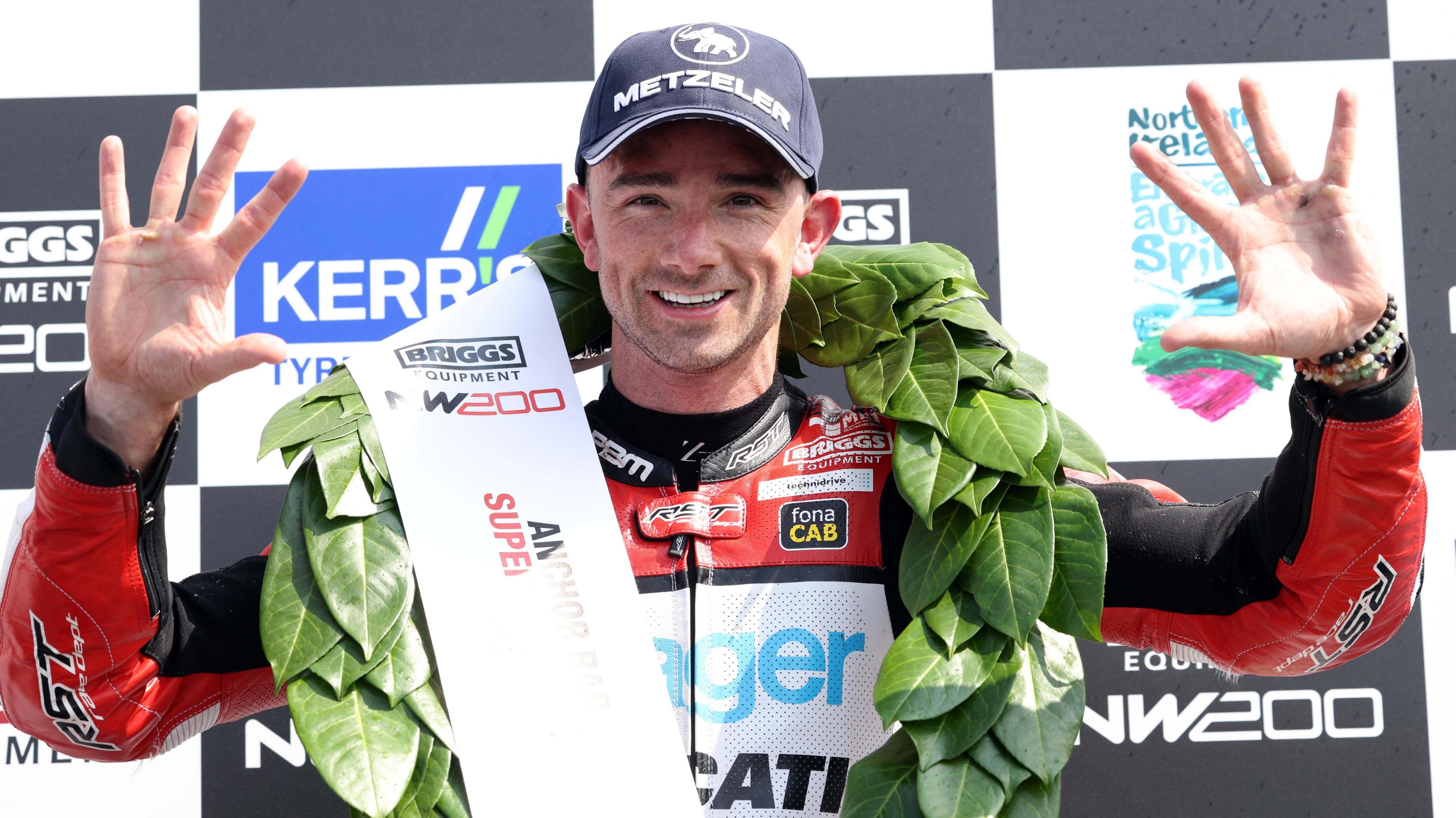 Glenn Irwin celebrates on the podium